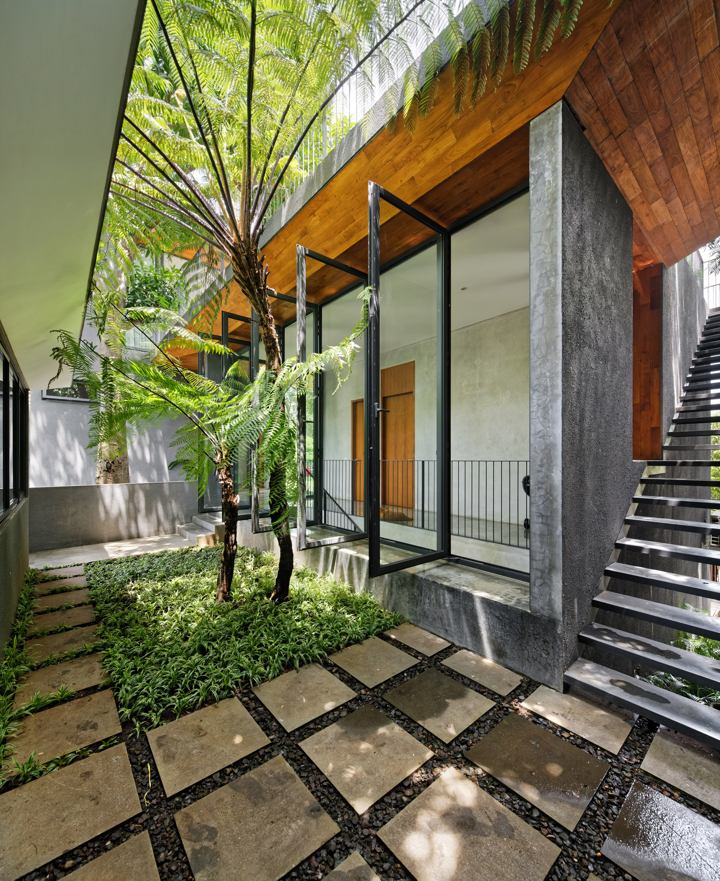 Pivoting doors offer breezes at Tamara Wibowo's Indonesian home-14