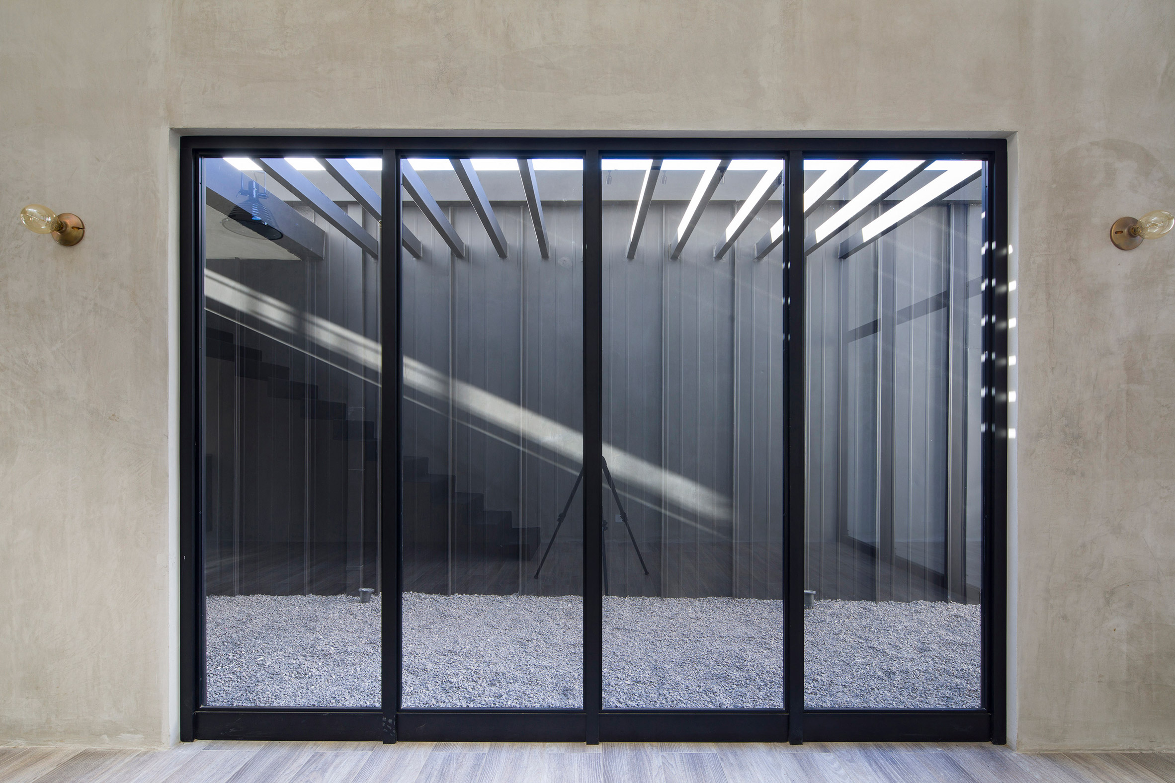 Outdoor terrace divides two sides of zinc and concrete home in Costa Rica-18