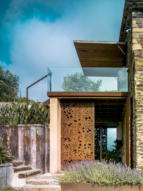 Weathered steel and stone combine in Zest Architecture's restored farmhouse-6
