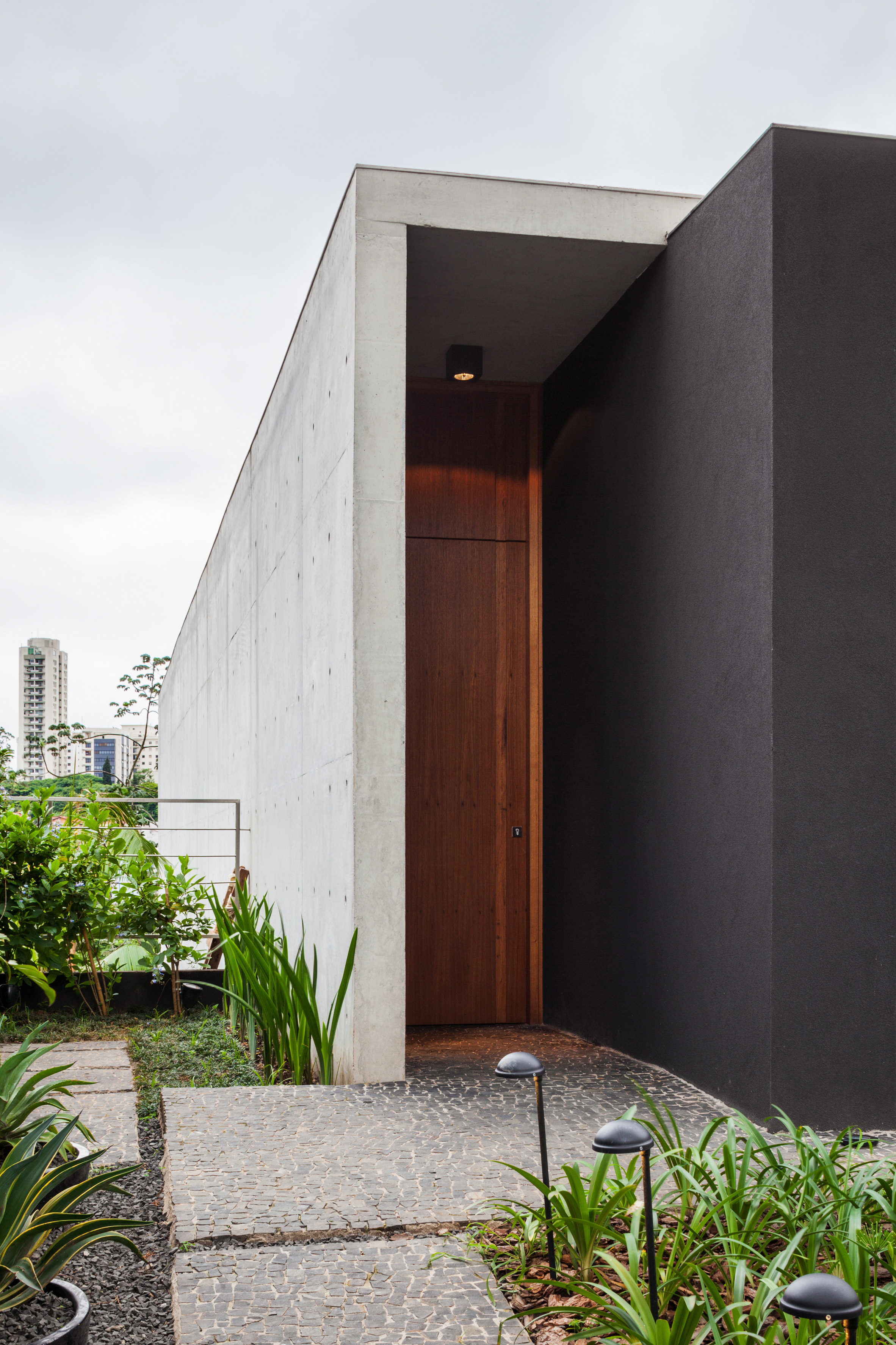 Concrete volume appears to rest on glass in Brazilian house by FGMF Arquitetos-6