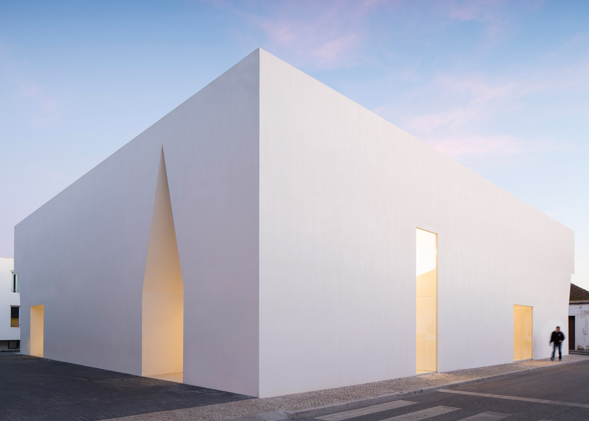 Irregular cutouts mark entrances to Aires Mateus' community centre in Portugal-2