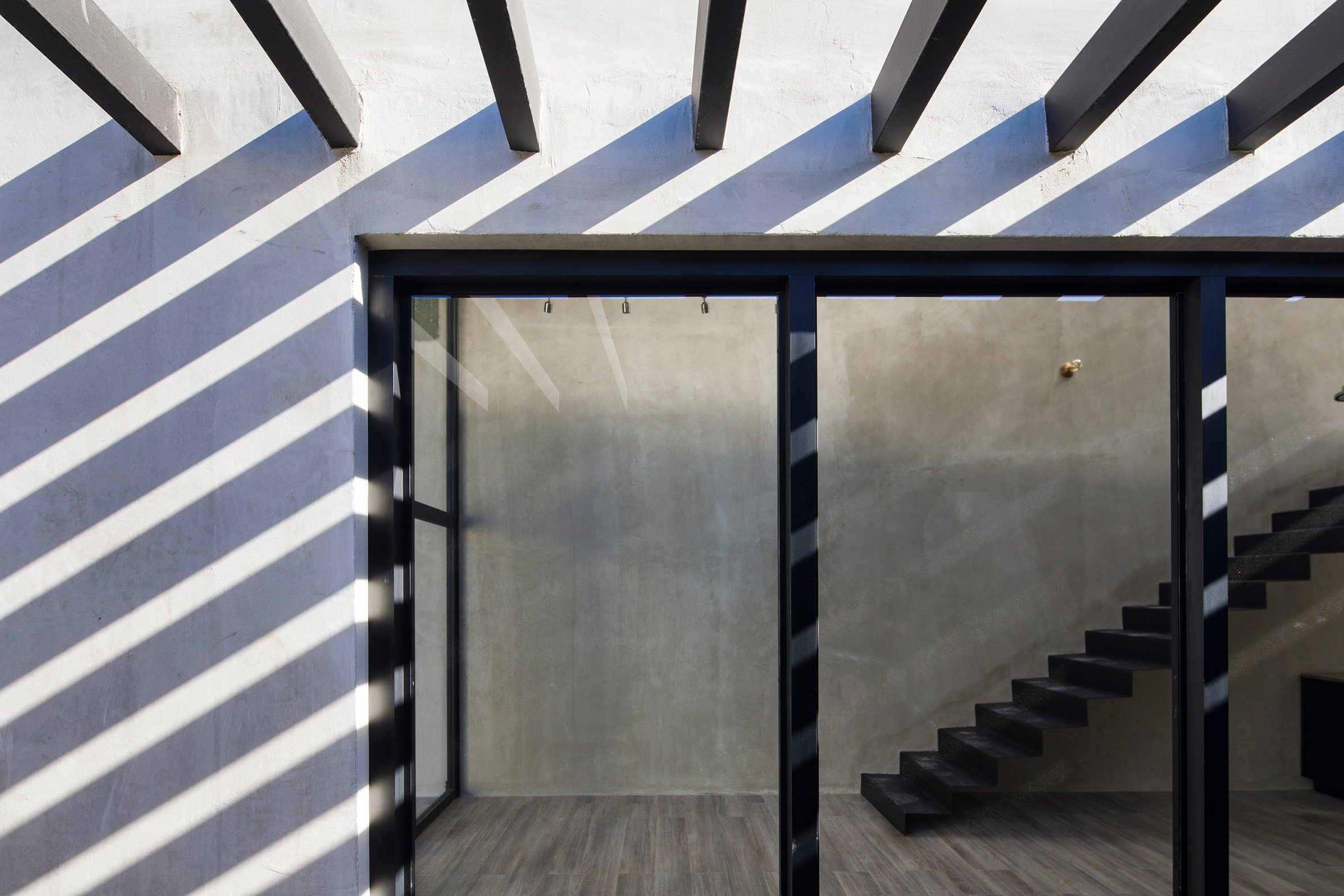 Outdoor terrace divides two sides of zinc and concrete home in Costa Rica-7