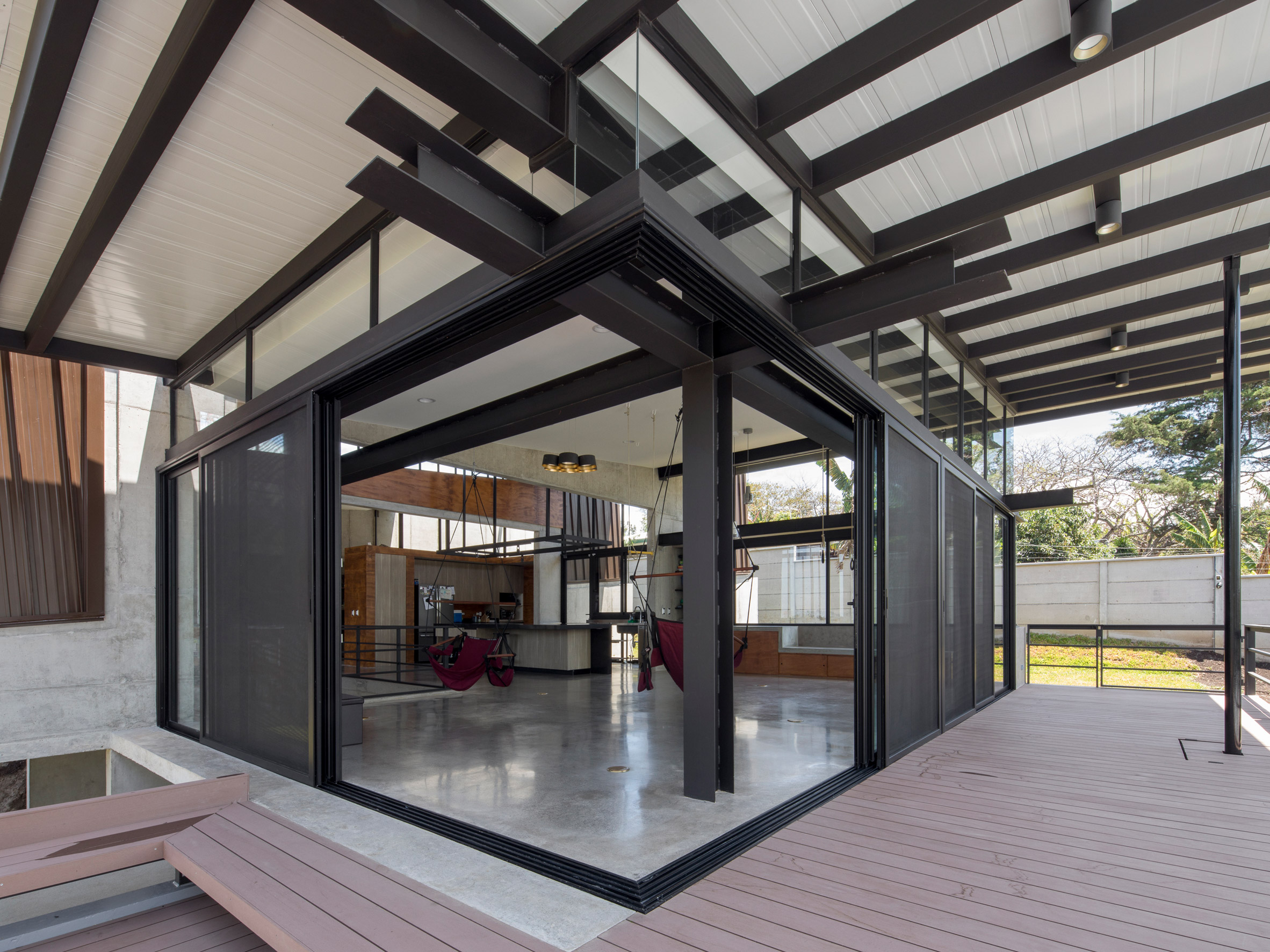 Grove of trees shades hillside Costa Rican house by Carazo Arquitectura-9