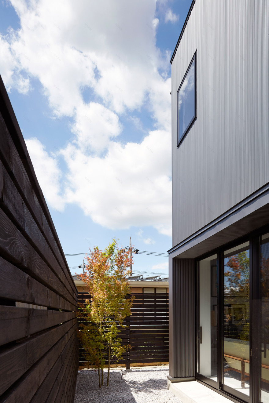 Black corrugated metal encases loft-inspired interiors of Japanese house by TakaTina-7