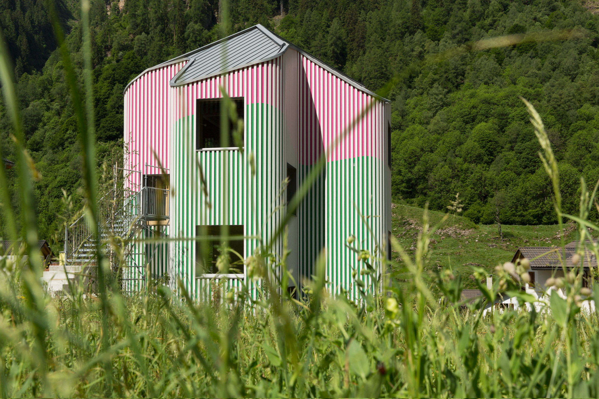 Swathes of green and pink paint cover undulating walls-2