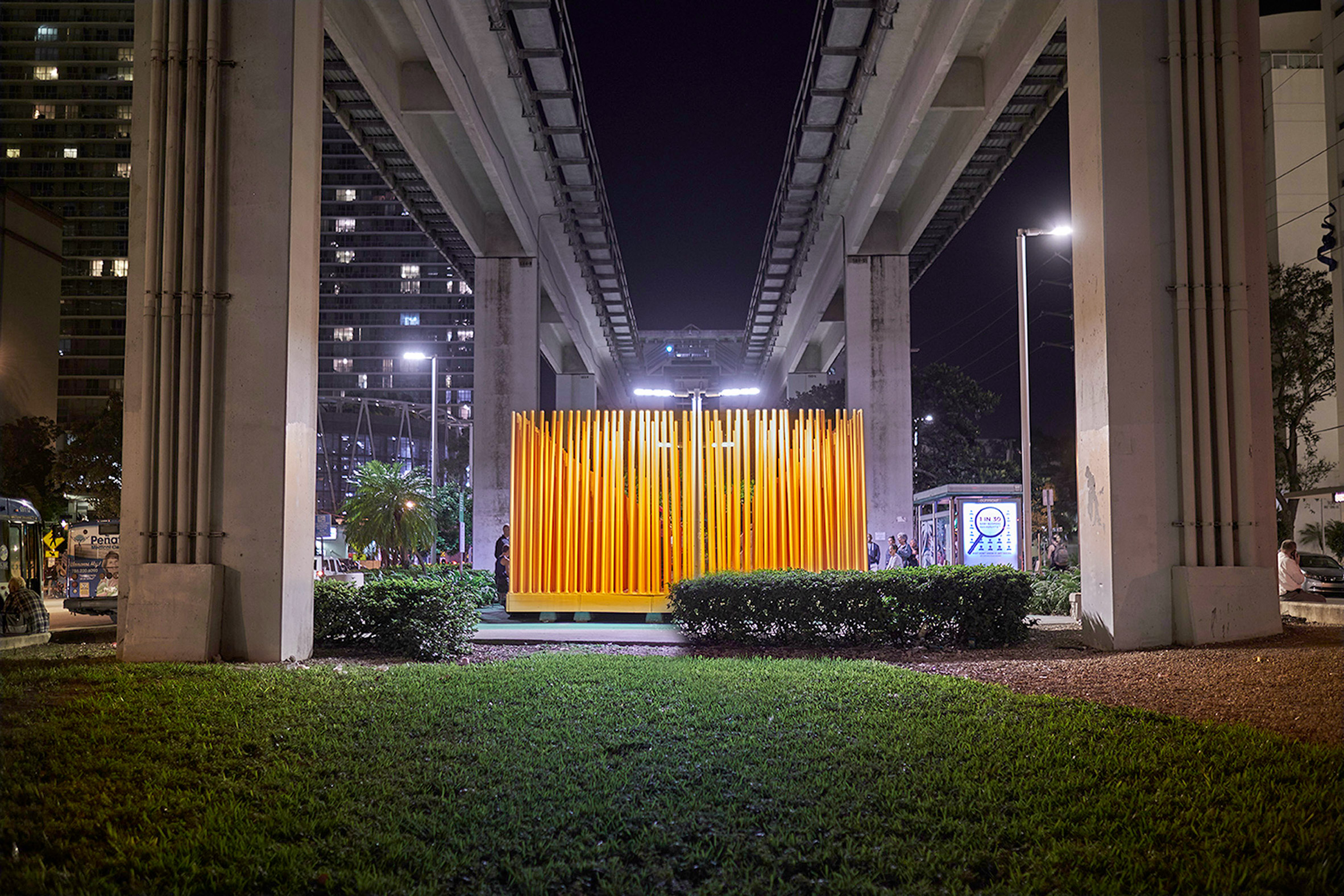 Architecture students install bright orange stage below Miami transit station-11