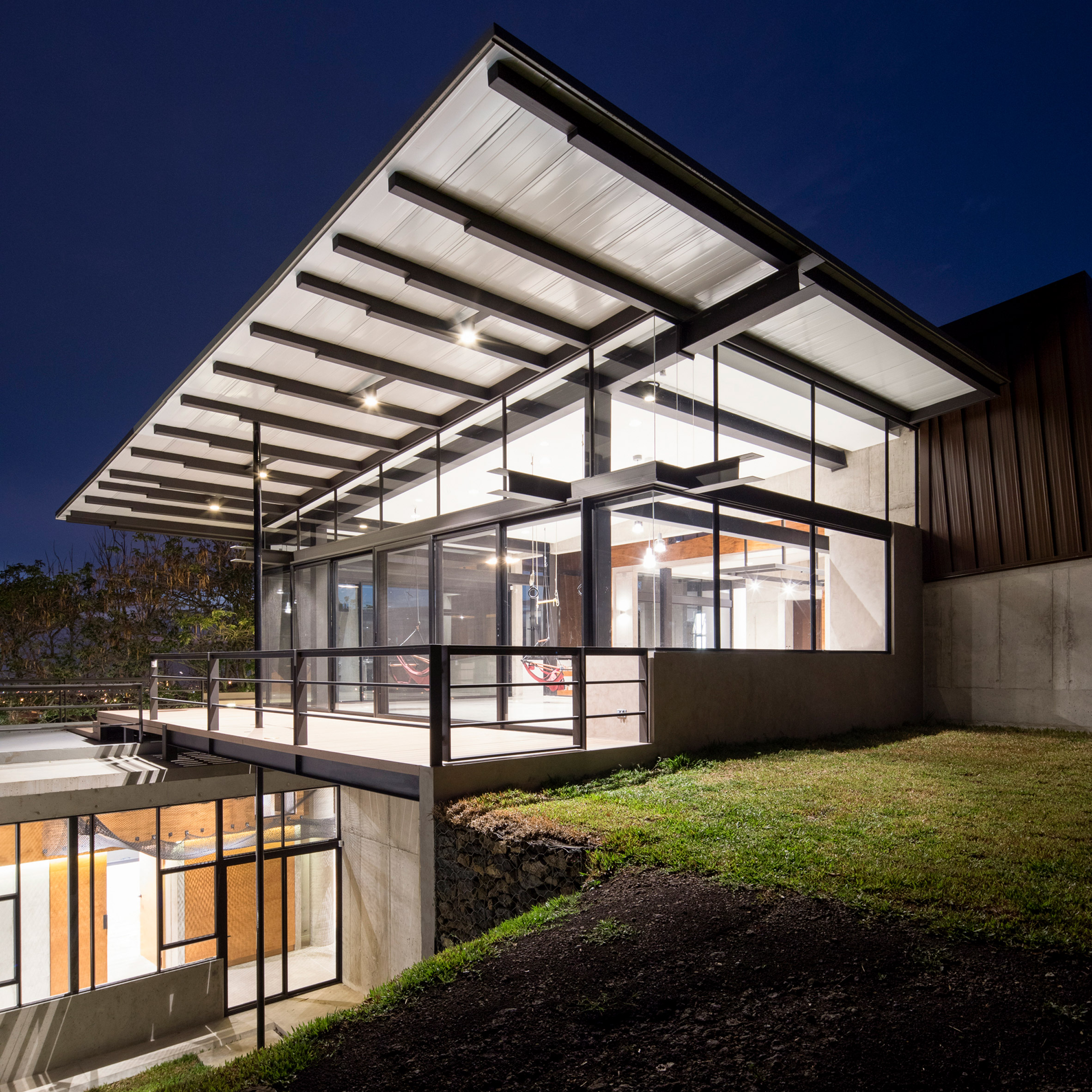 Grove of trees shades hillside Costa Rican house by Carazo Arquitectura-0