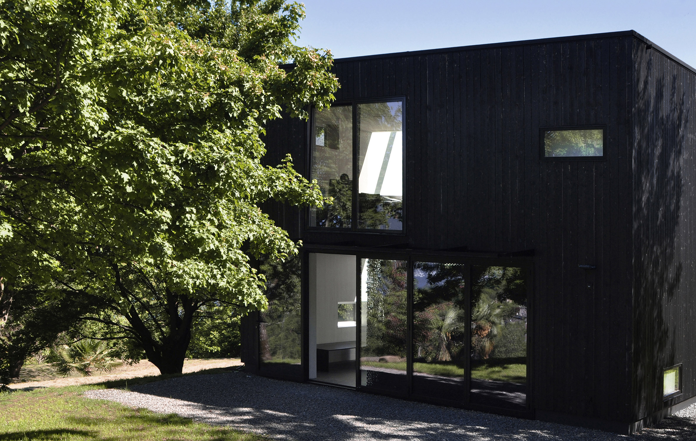 This prefabricated wooden holiday home is clad in charred timber boards-14
