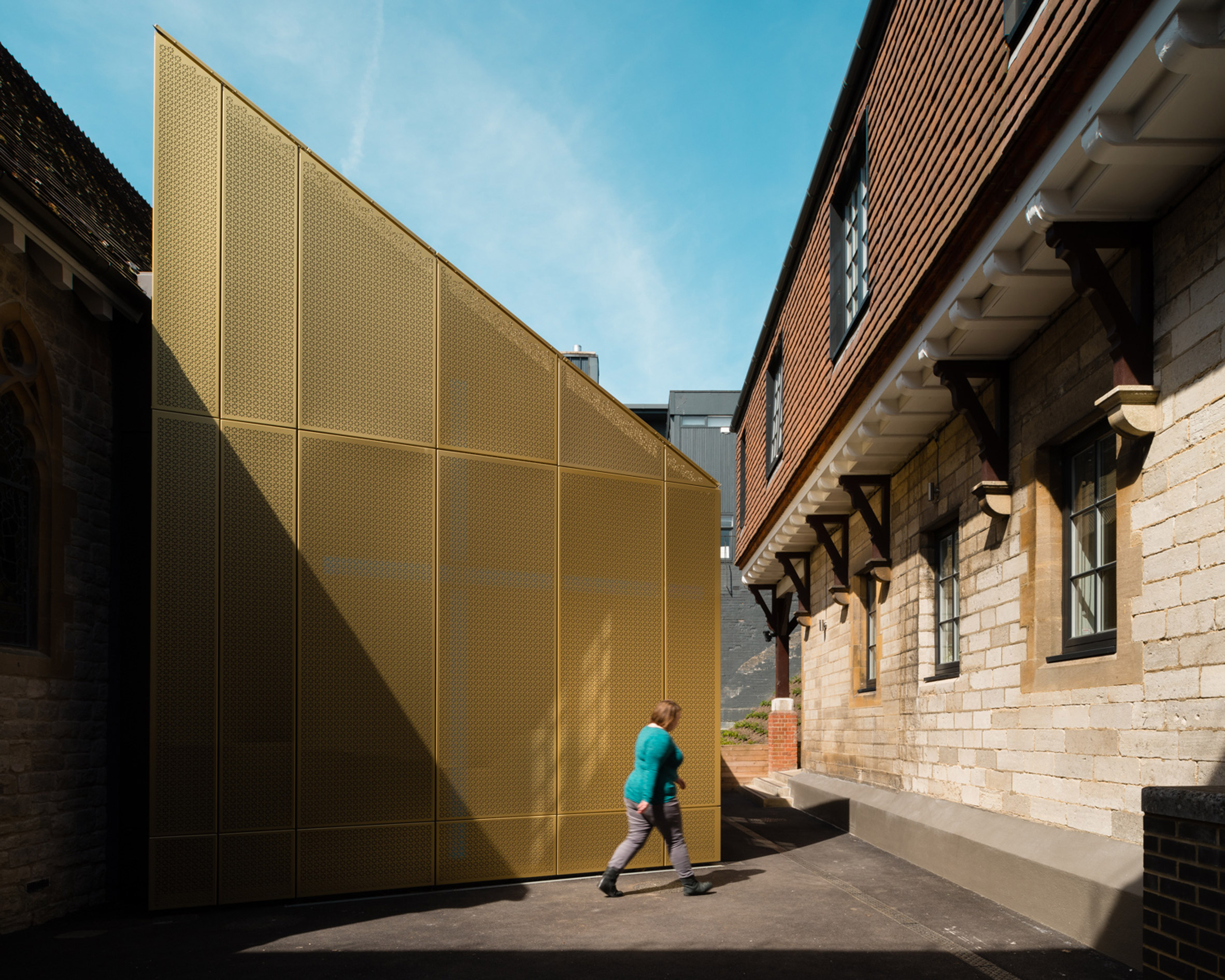 Gold extension added to Winchester university chapel by Design Engine-11