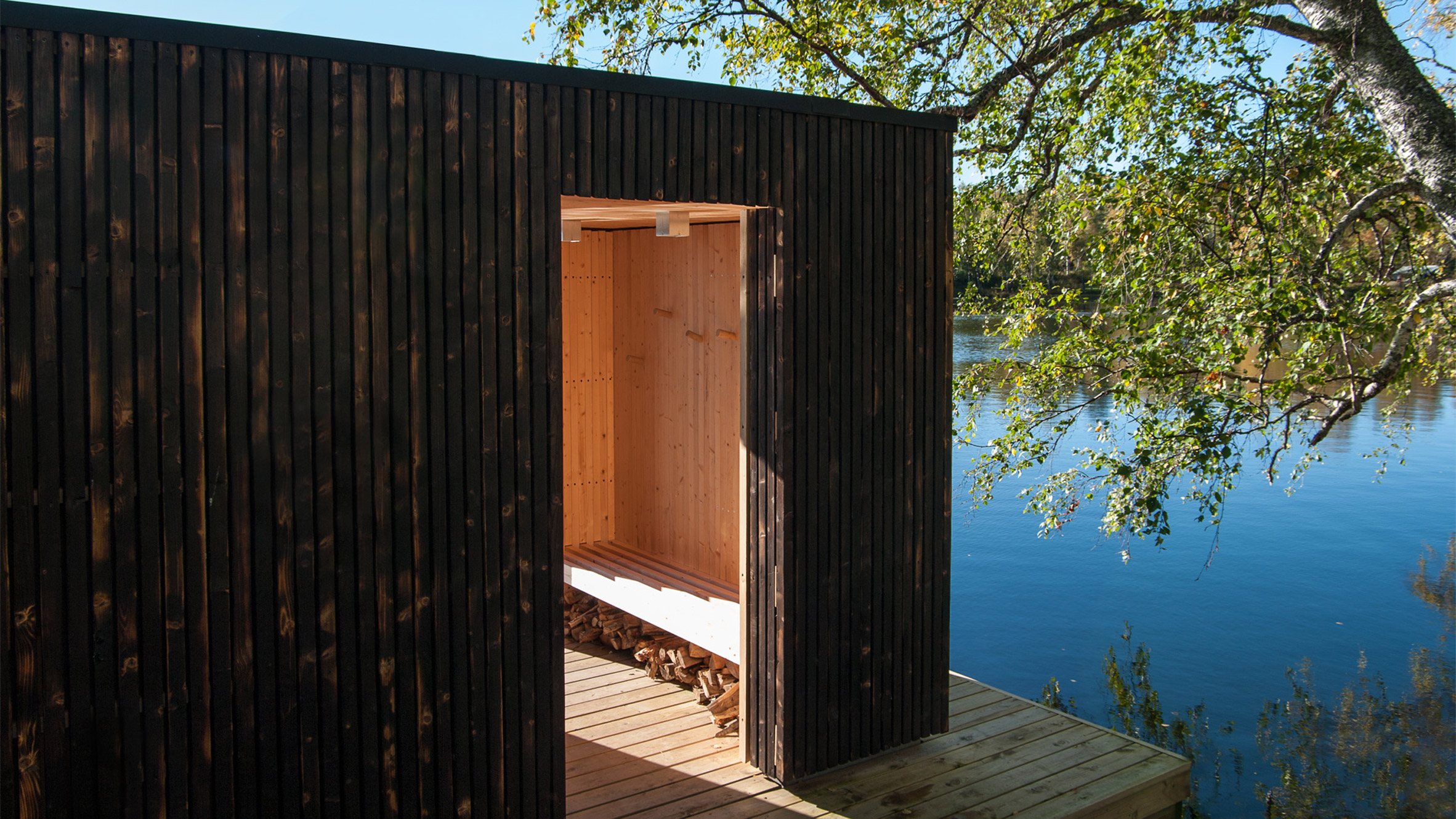 Small Architecture Workshop's charred-wood sauna floats on Swedish lake-17