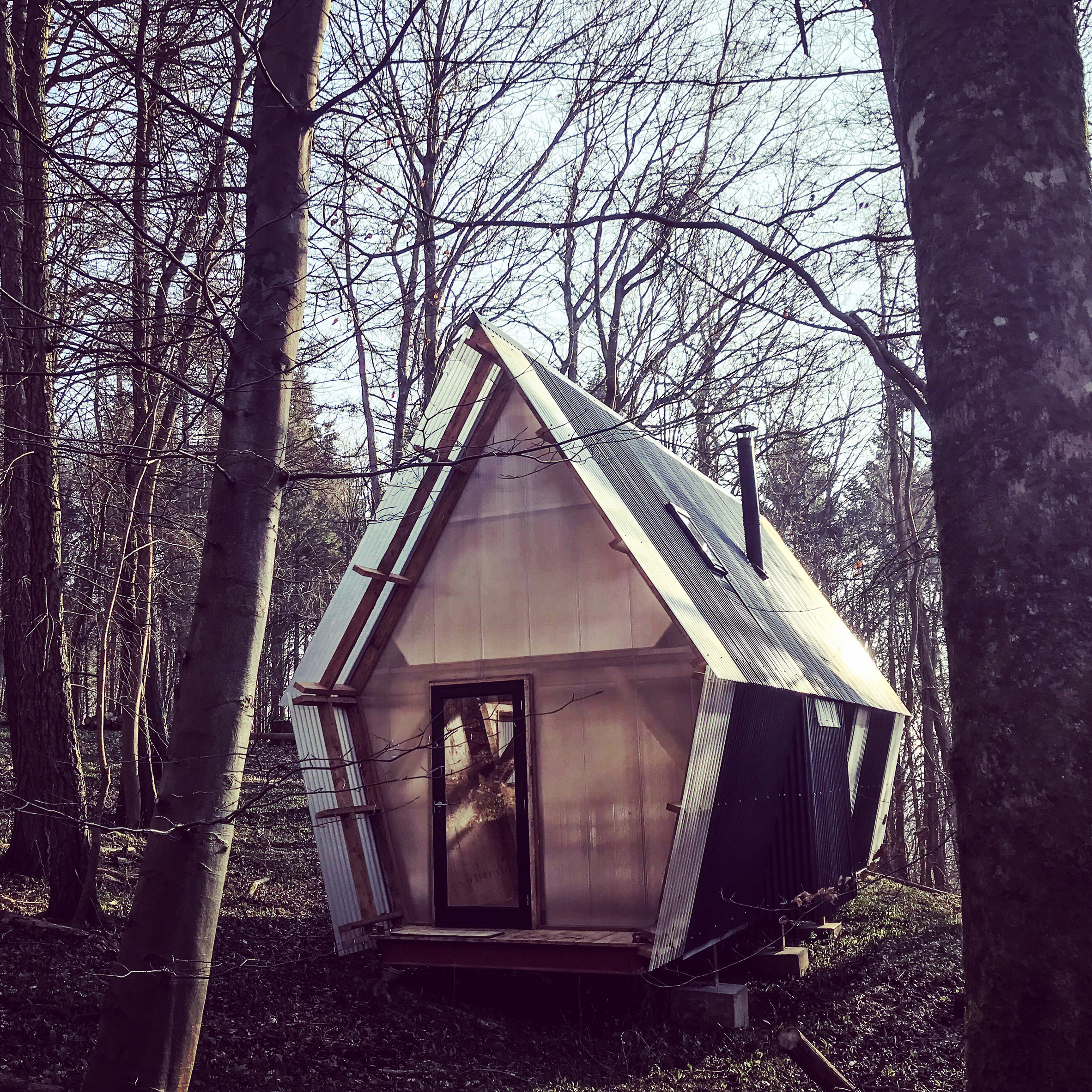 Low-cost micro home is made from timber and scavenged materials-0