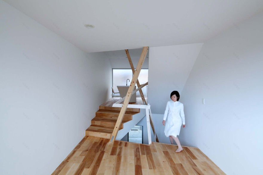 Timber frame projects into rooms and stairwell of compact Kyoto home-8