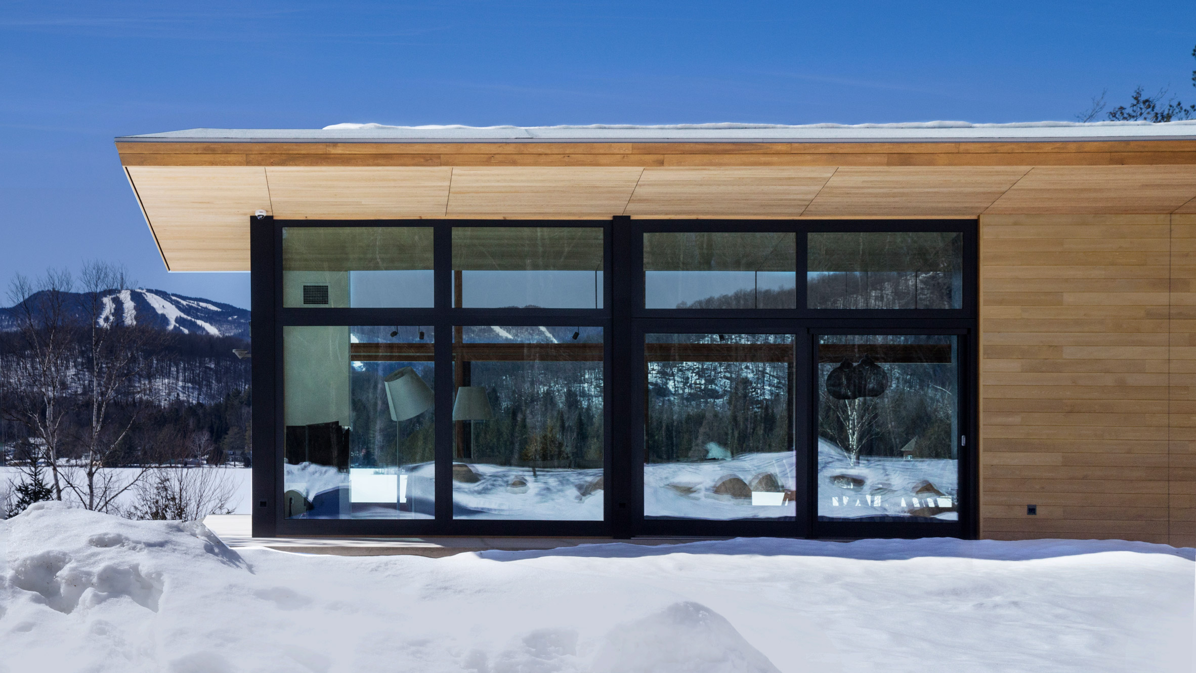 Quebec ski chalet by YH2 features V-shaped roof modelled on bird's wings-0