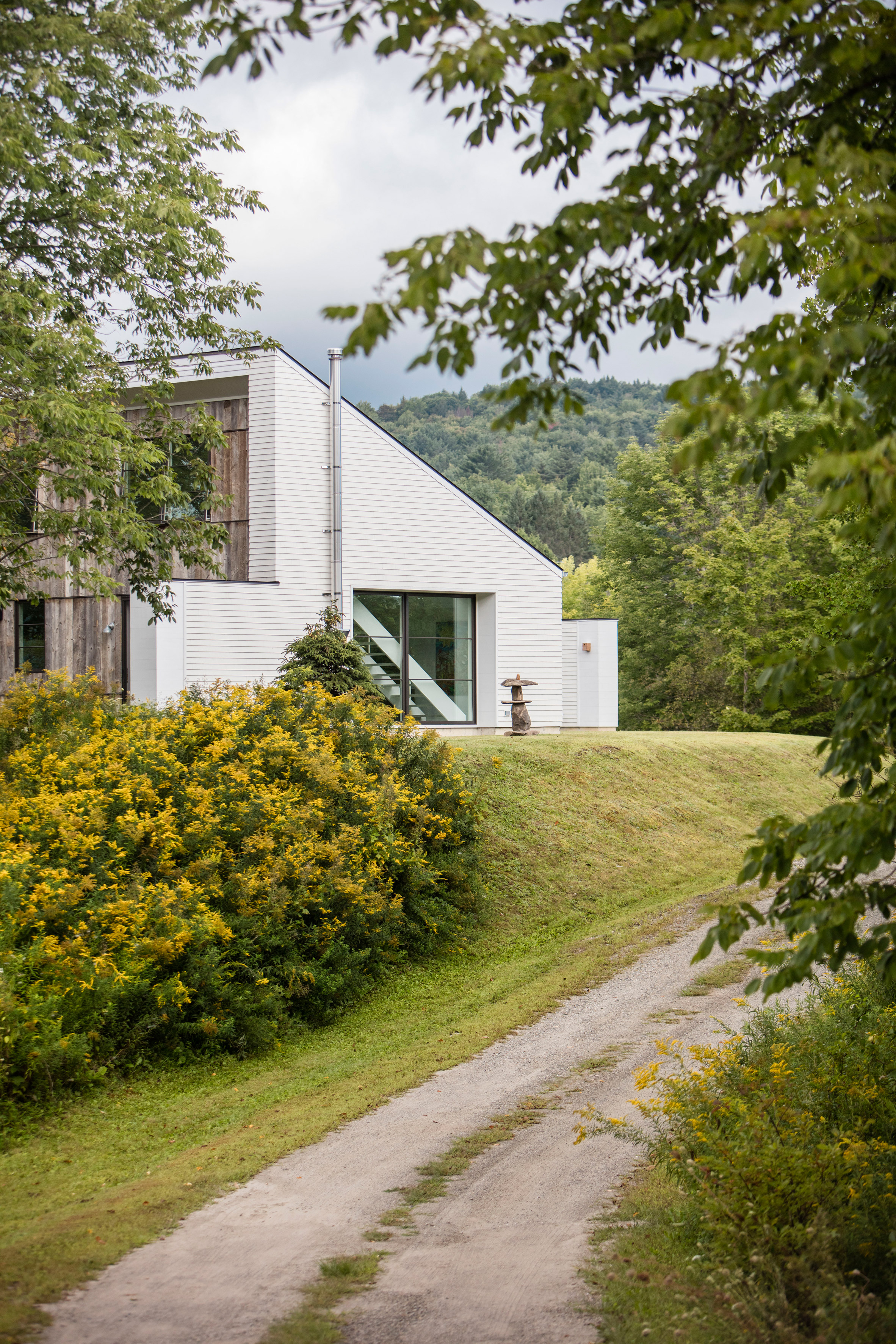 Two white volumes frame central courtyard of Vermont home by Birdseye Design-21