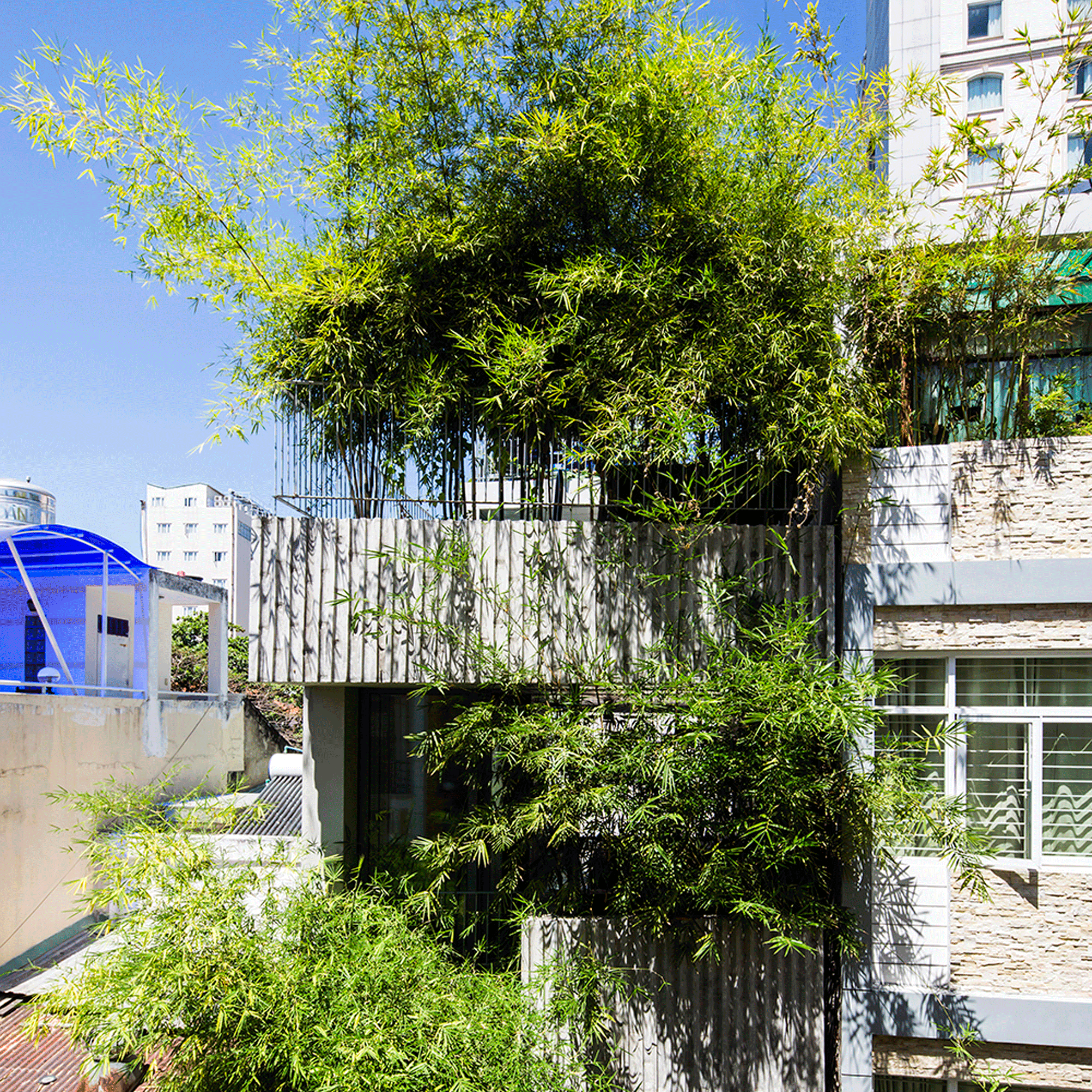 Vo Trong Nghia fronts narrow house in Vietnam with huge bamboo plant boxes-0