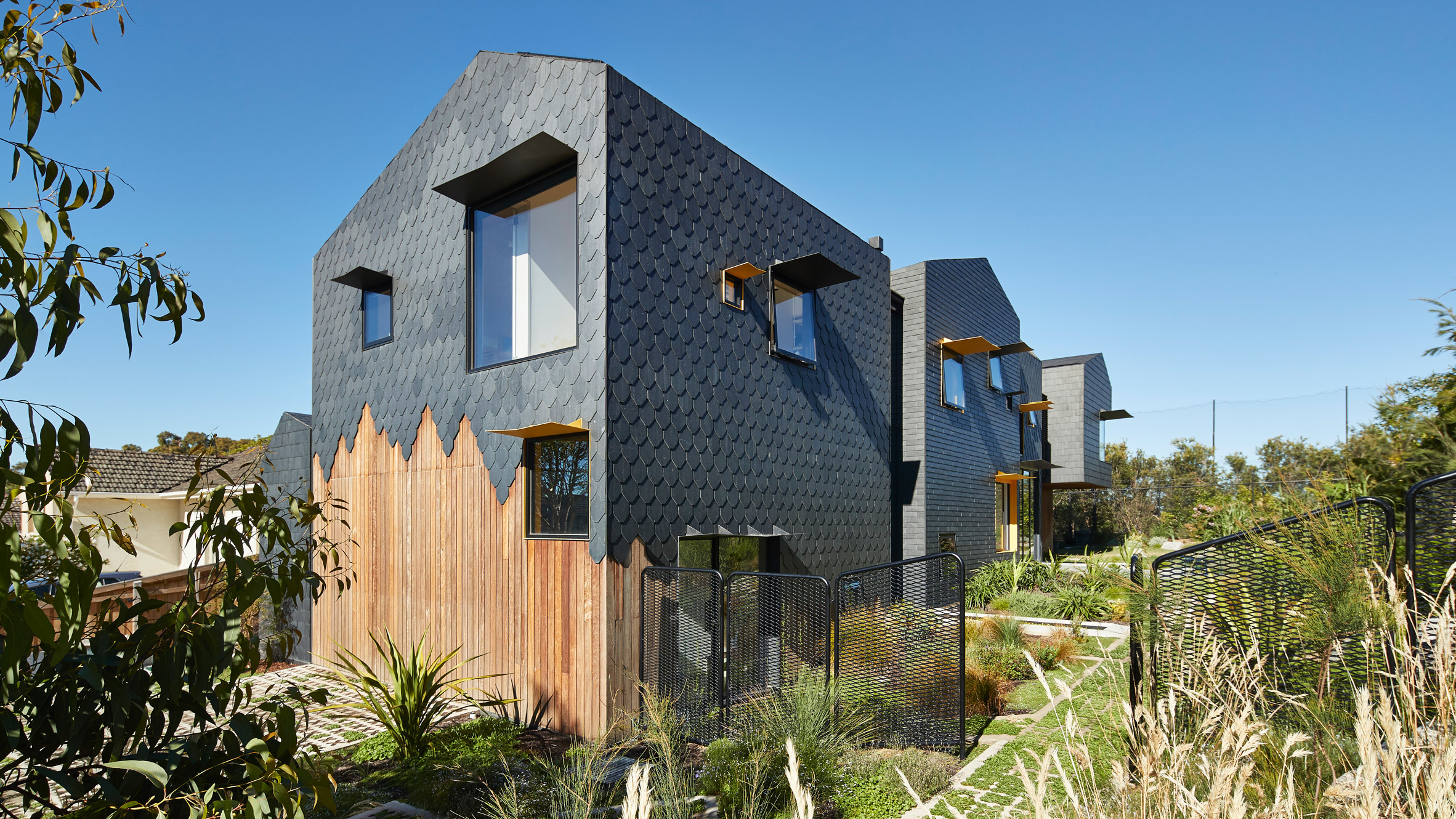 Diamond, scalloped and brick-shaped shingles cover Melbourne house by Austin Maynard Architects-0