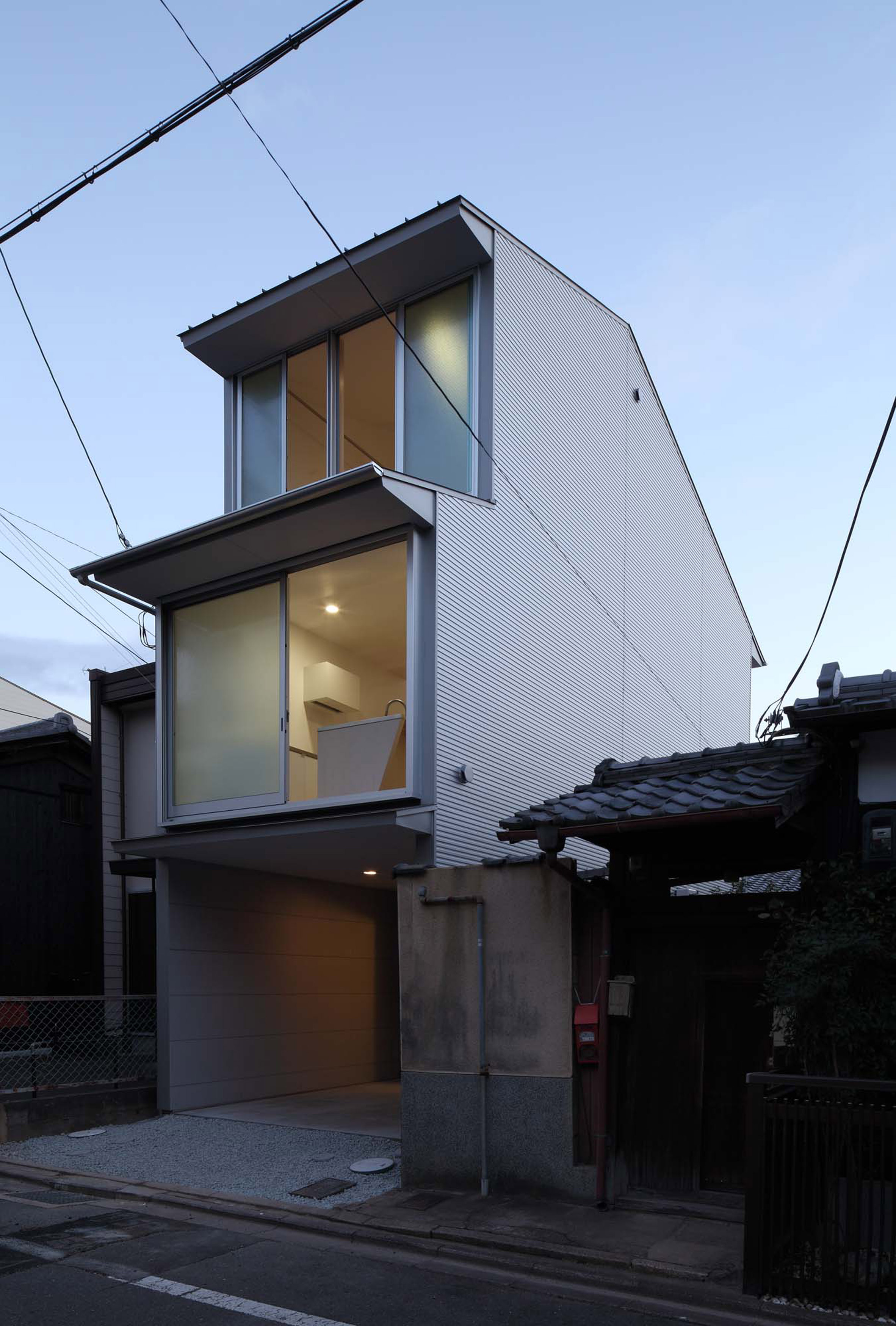 Timber frame projects into rooms and stairwell of compact Kyoto home-20