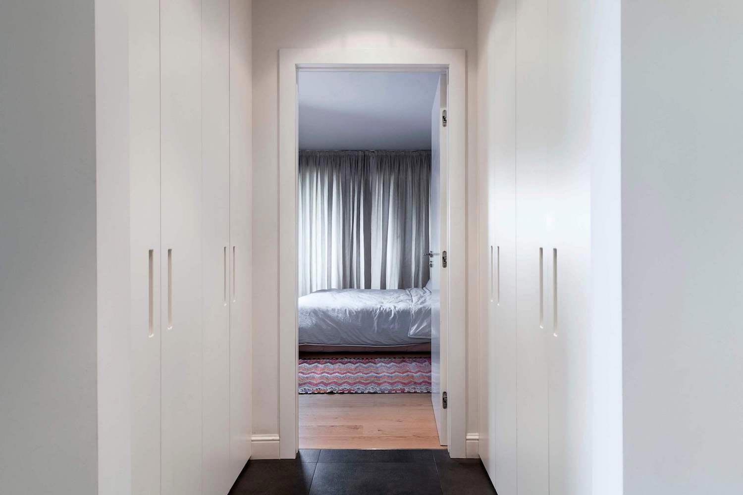 E2 Apartment designed in white and grey with a touch of a wood paneling around fireplace by Tchenguelieva Staynov Architects   CAANdesign  Architecture and home design blog-8