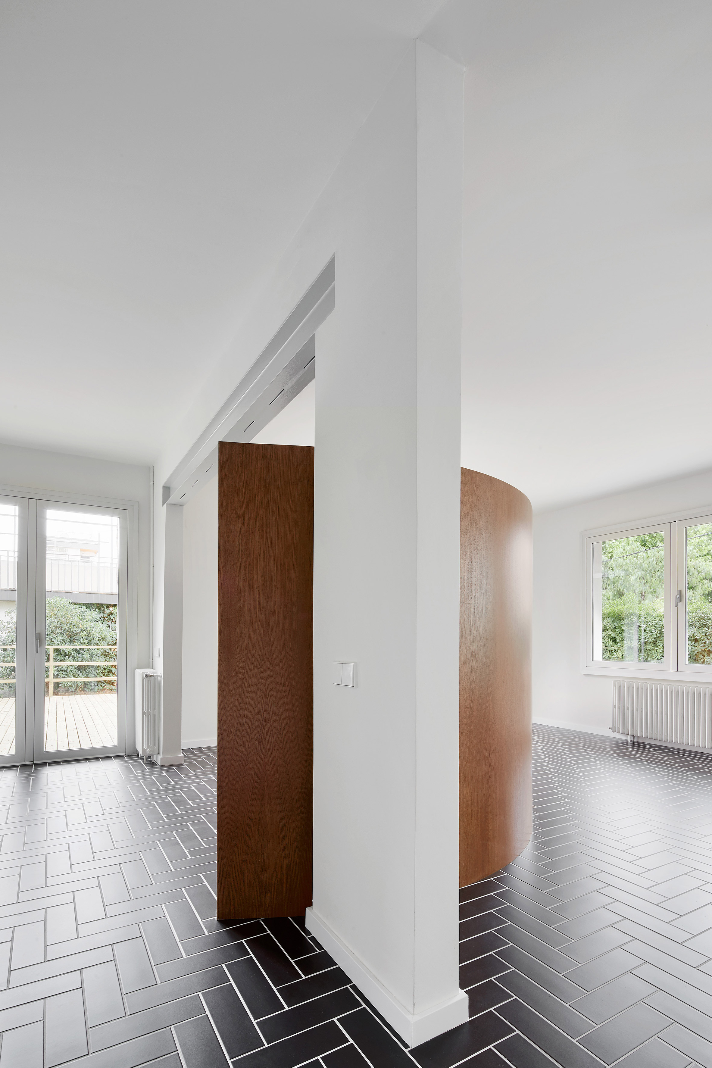 Revamped Barcelona house features herringbone floors and a covert dining area-8