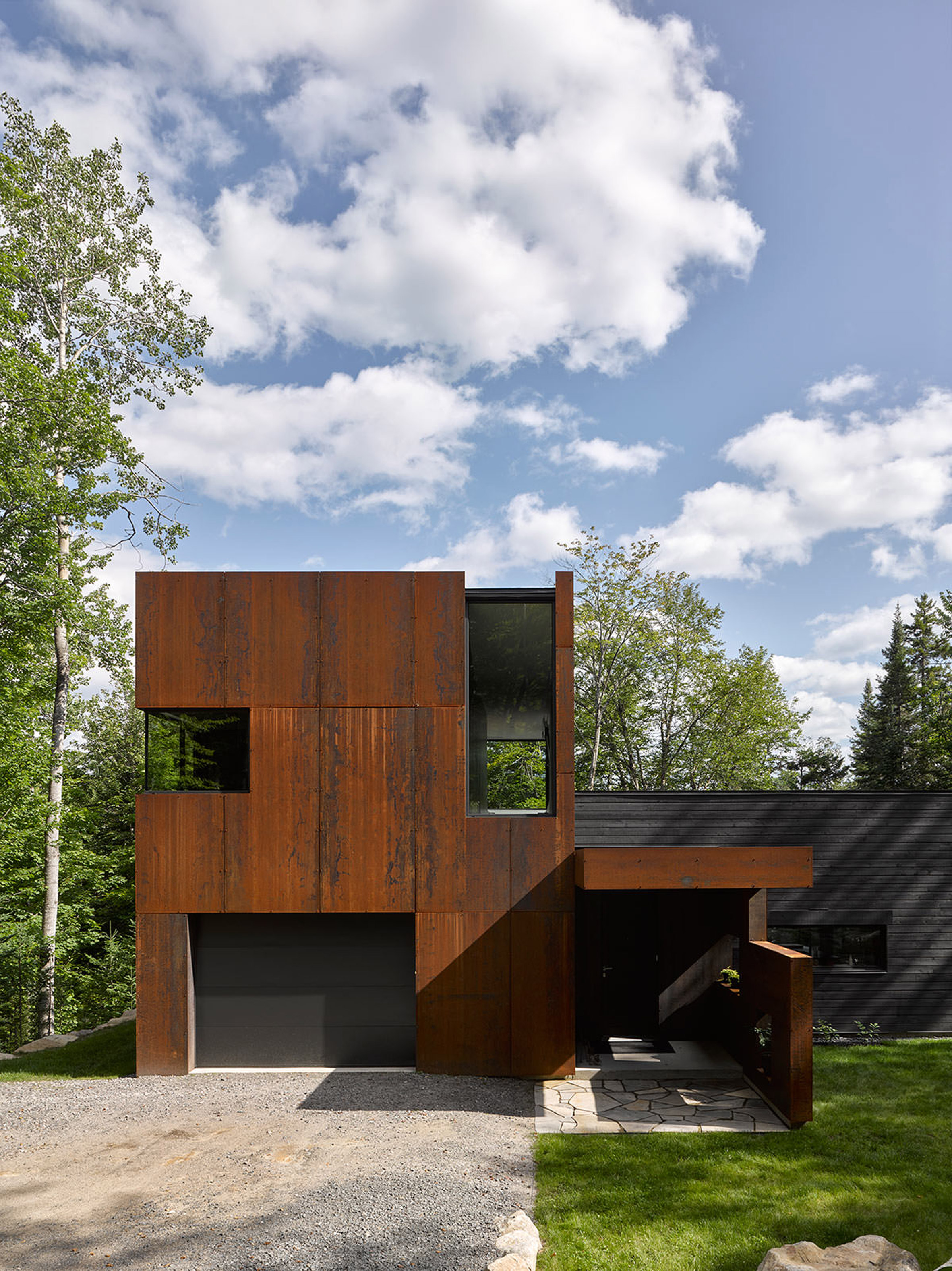Canadian lake house by Paul Bernier features dark rusted metal cladding-2