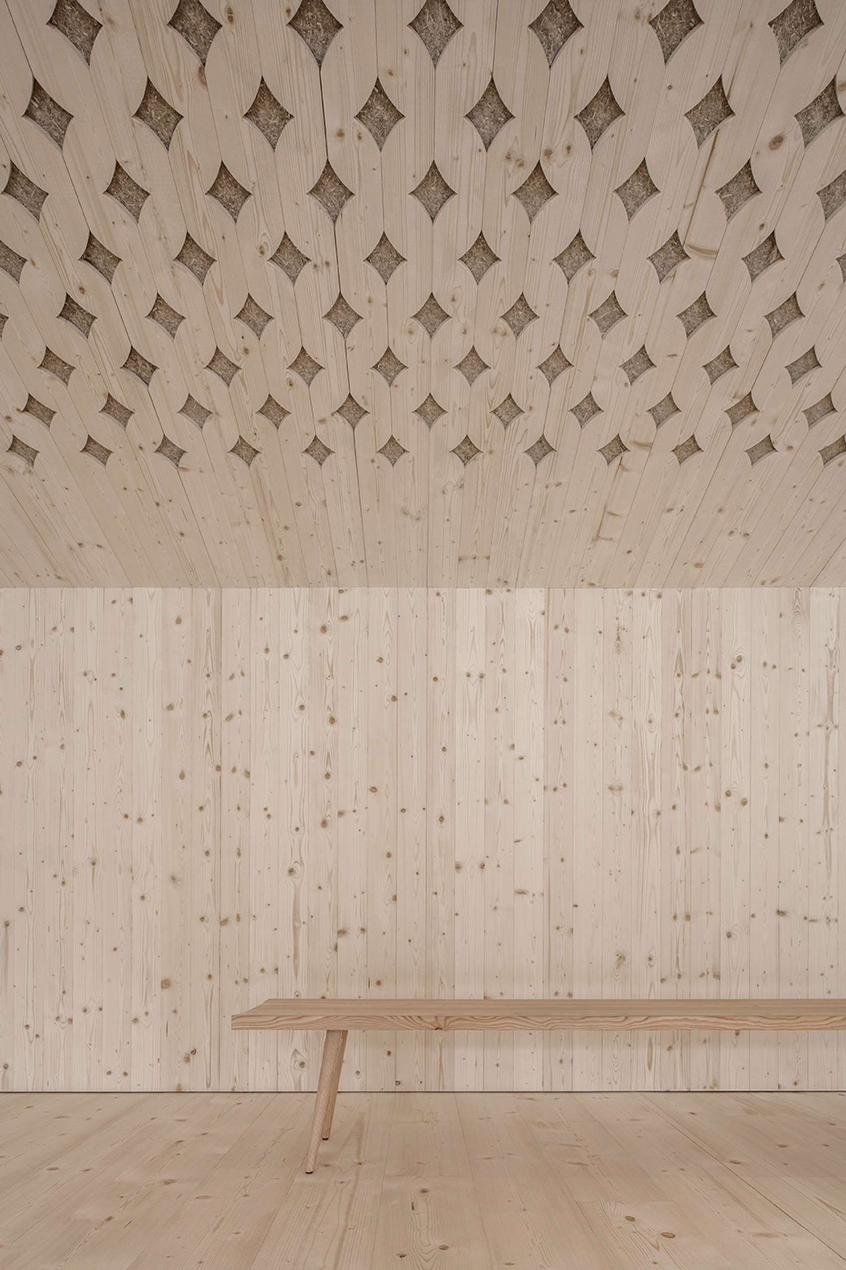 Pedevilla Architects lines cookery school with perforated timber panels-14