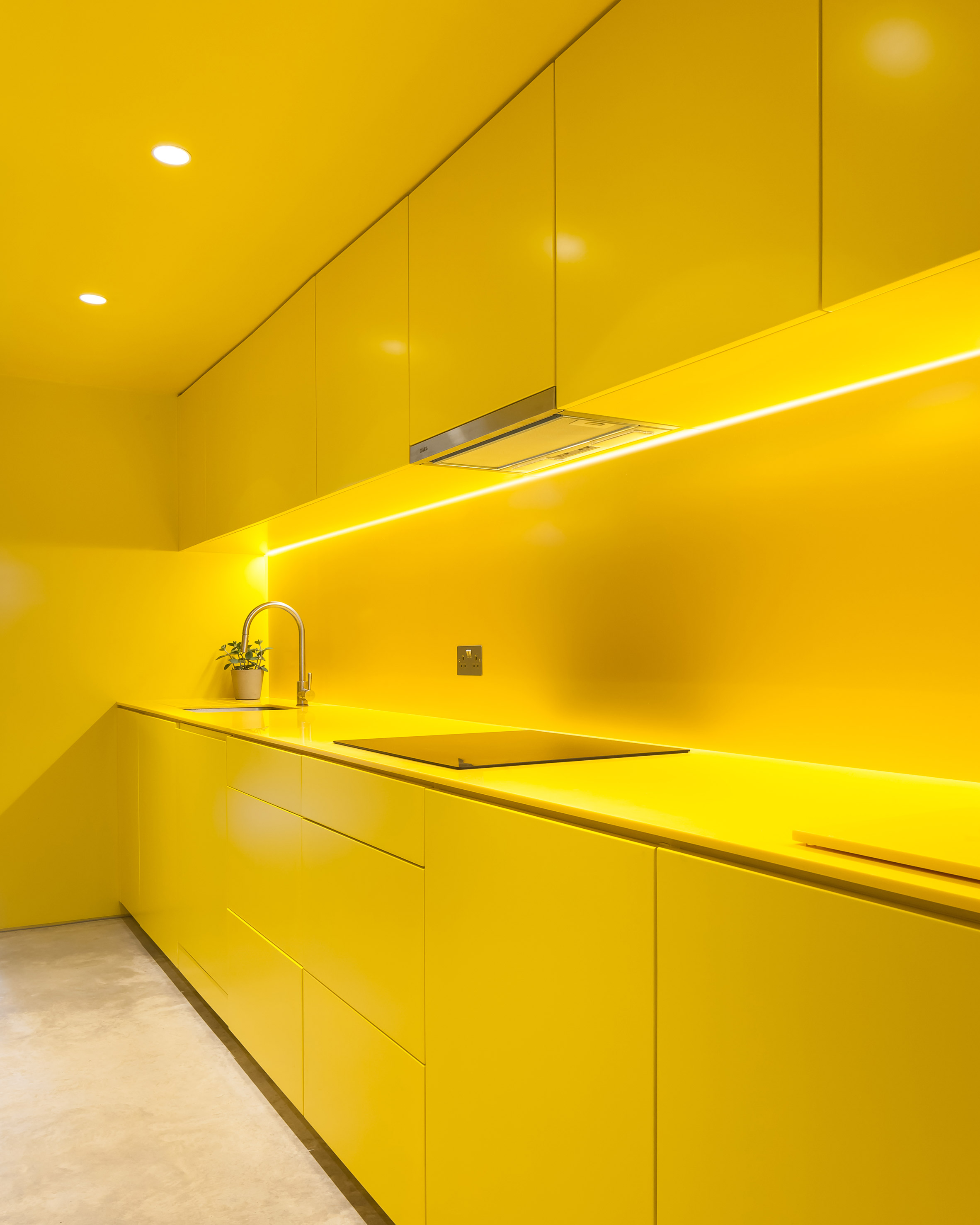 Yellow kitchen brightens basement of north London home-3