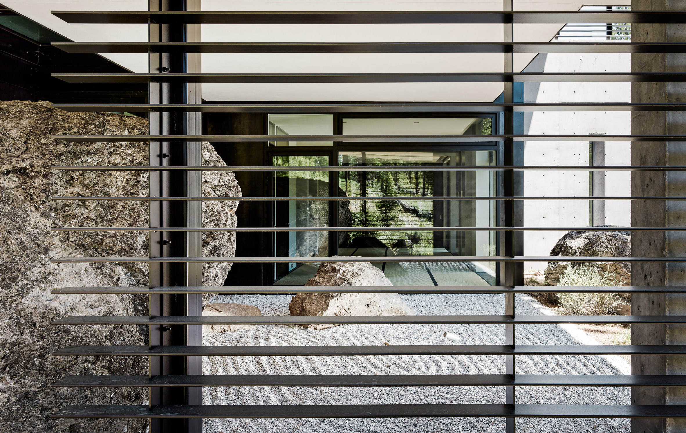 Creek House by Faulkner Architects preserves boulders on steep site-16