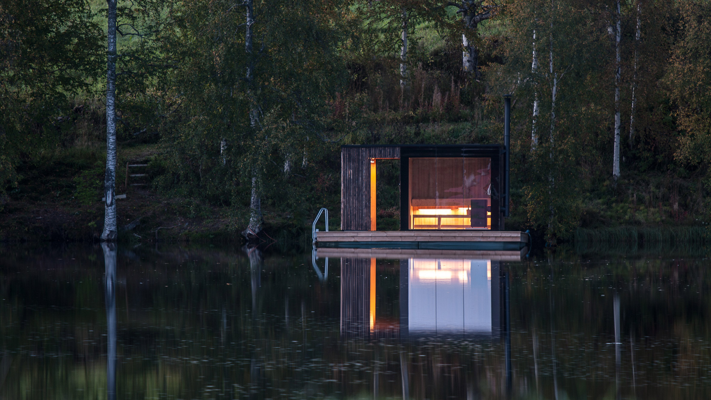 Small Architecture Workshop's charred-wood sauna floats on Swedish lake-14