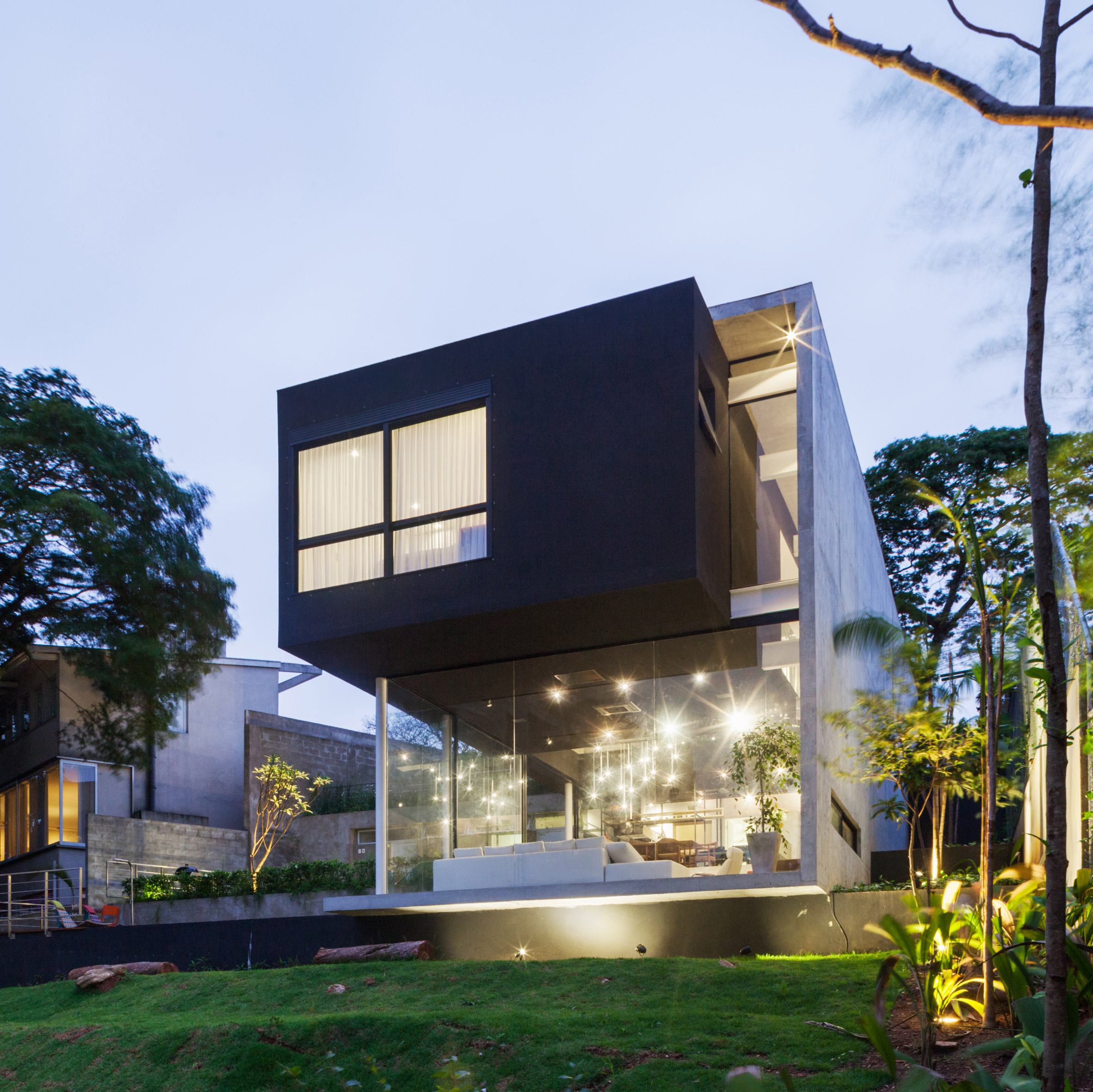 Concrete volume appears to rest on glass in Brazilian house by FGMF Arquitetos-0