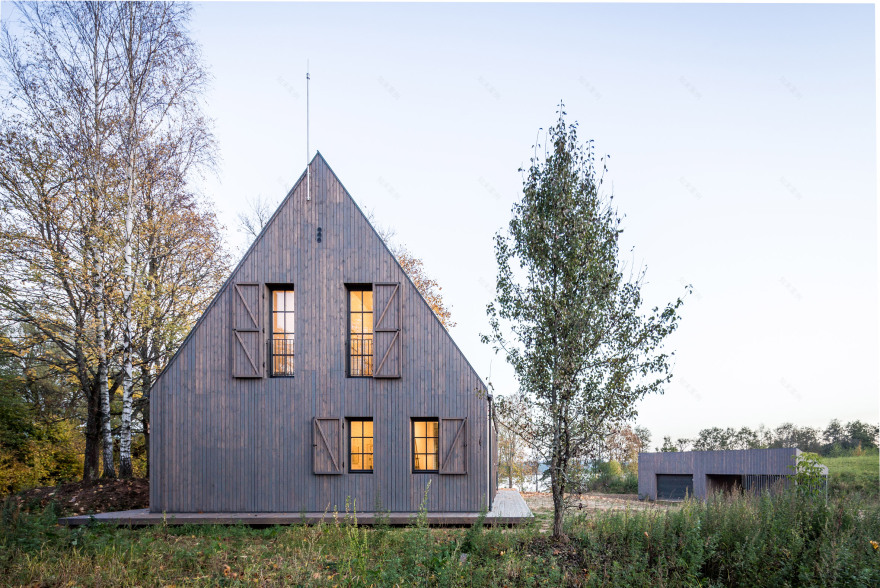 Aketuri Architektai conceals windows and doors behind large timber shutters at Lithuanian lakeside retreat-2