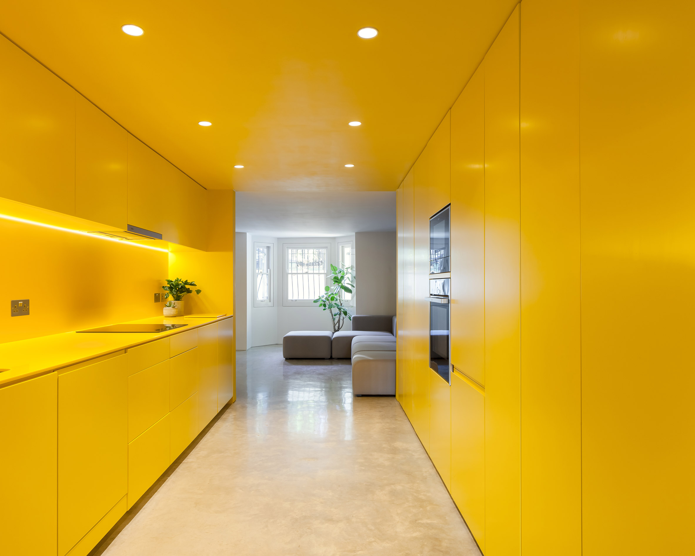 Yellow kitchen brightens basement of north London home-6