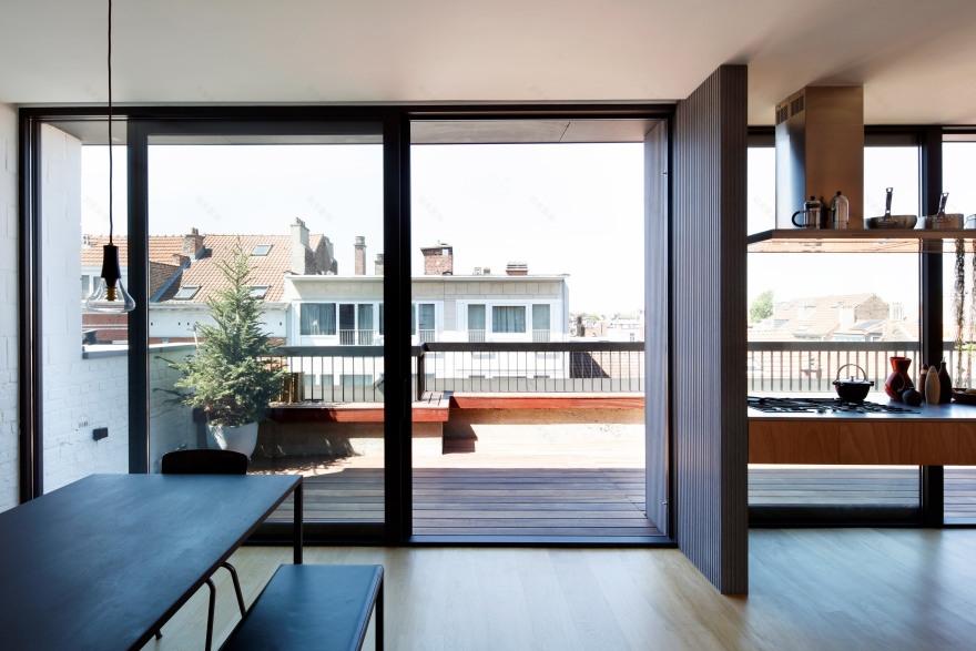 Alvar Aalto inspired the orange fireplace in this Brussels roof extension-22
