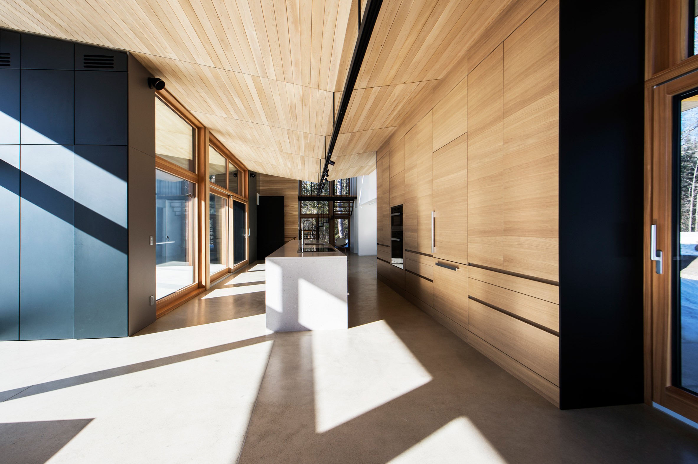 Quebec ski chalet by YH2 features V-shaped roof modelled on bird's wings-11