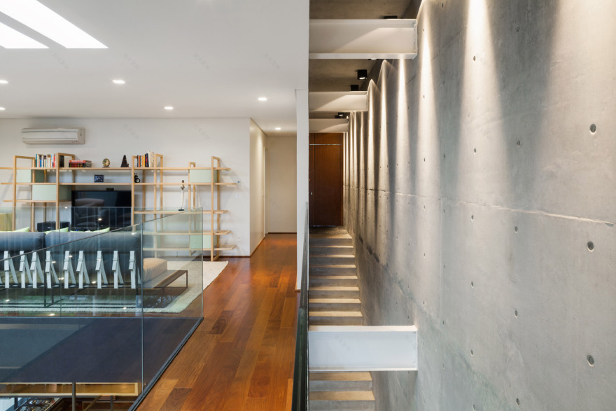 Concrete volume appears to rest on glass in Brazilian house by FGMF Arquitetos-9