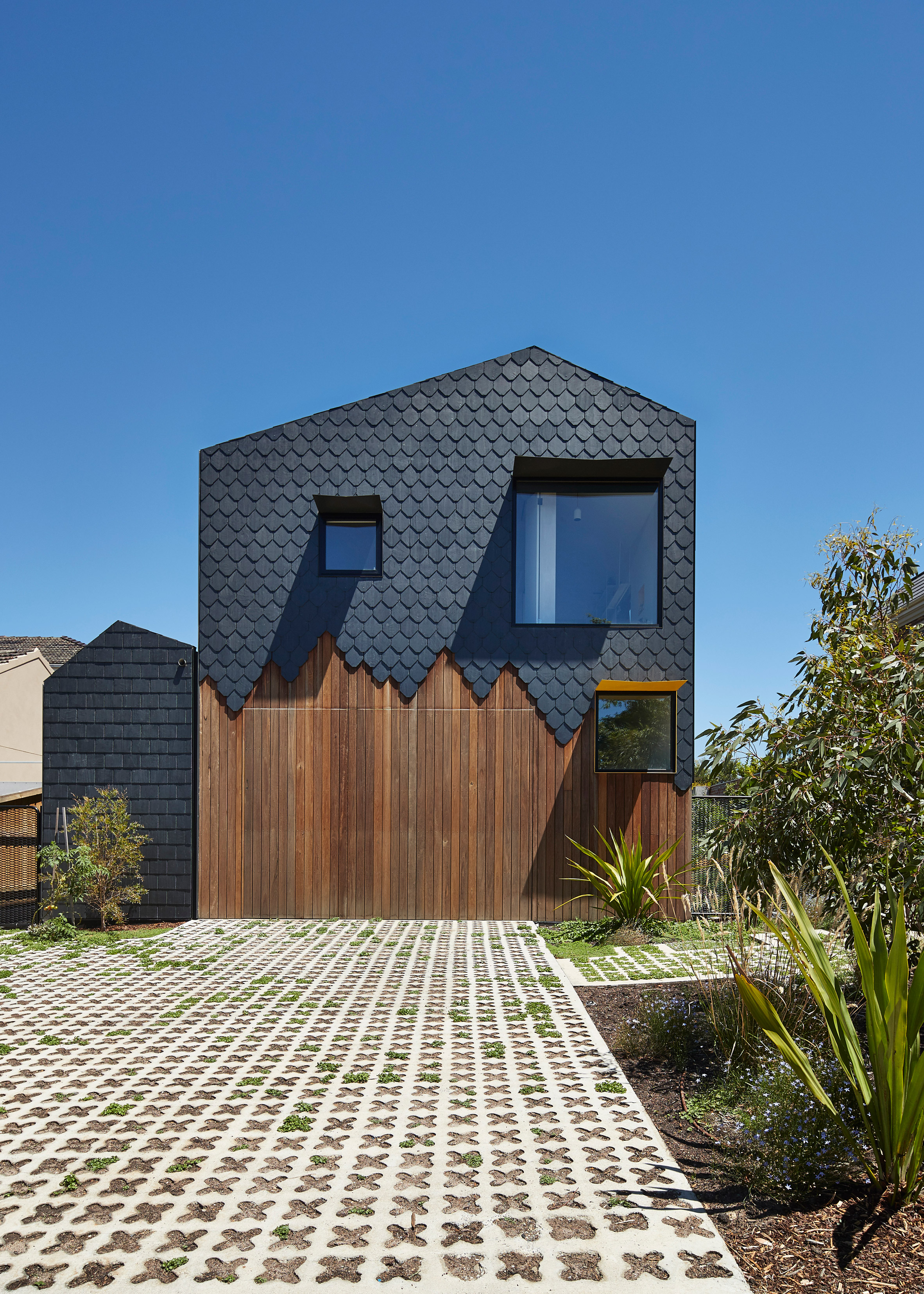 Diamond, scalloped and brick-shaped shingles cover Melbourne house by Austin Maynard Architects-5