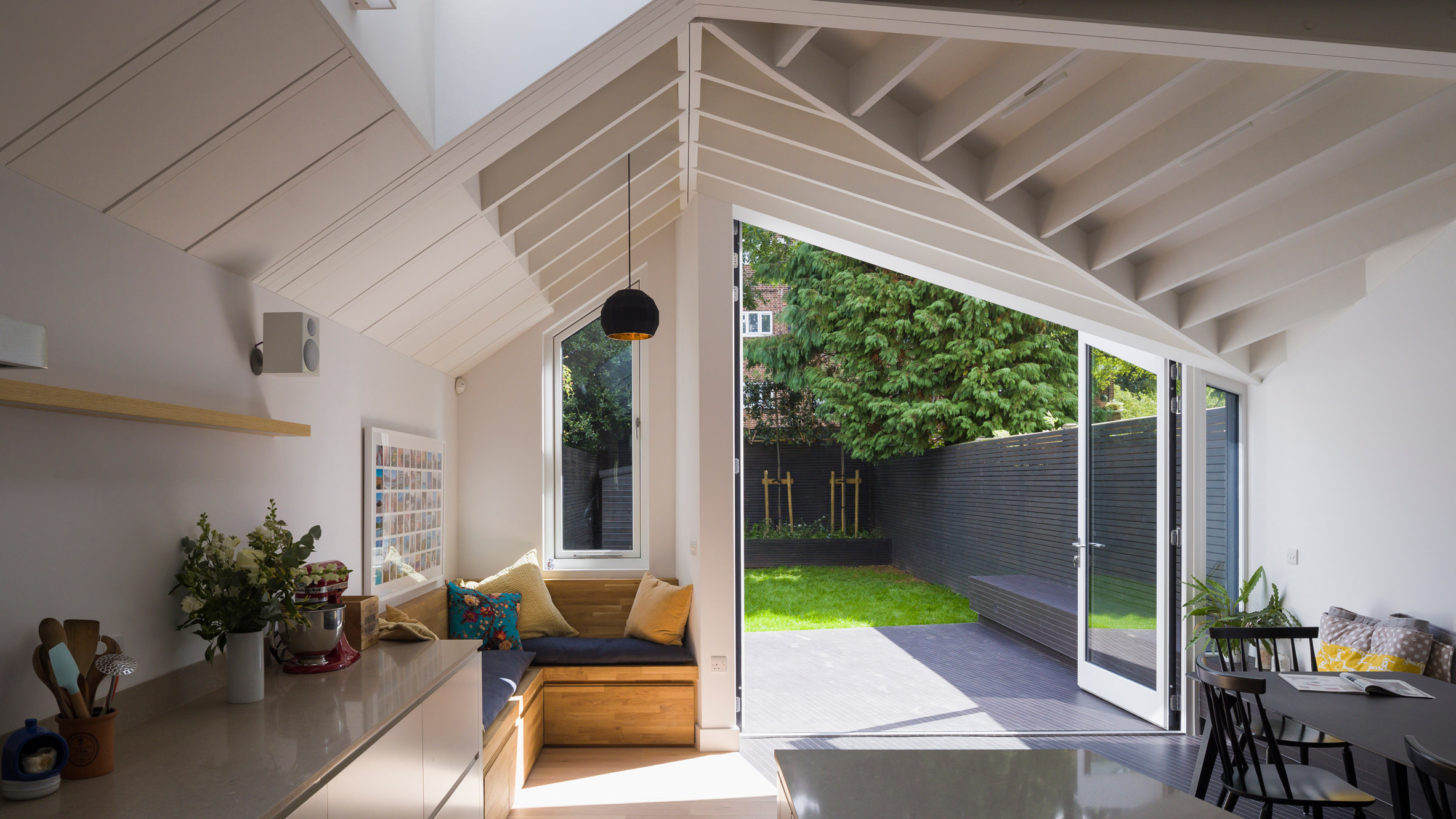 Angular doors connect tapered extension by Mustard Architects with patio-0
