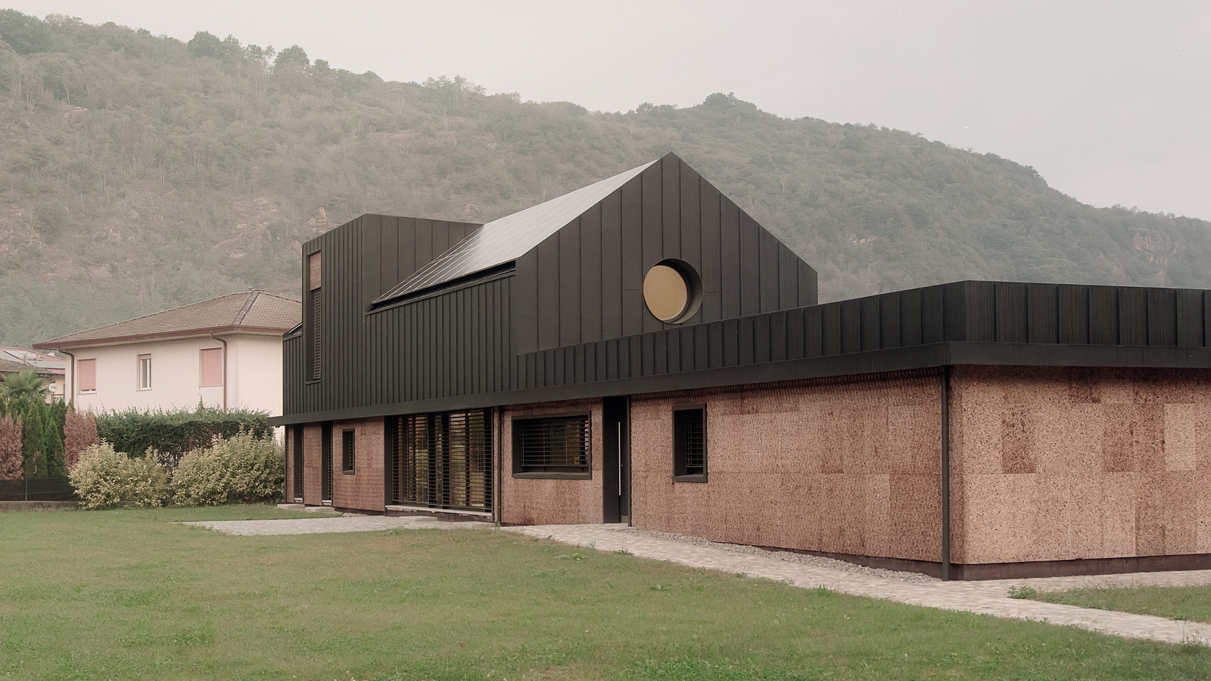 LCA Architetti nestles angular cork-clad home into Italian valley-0