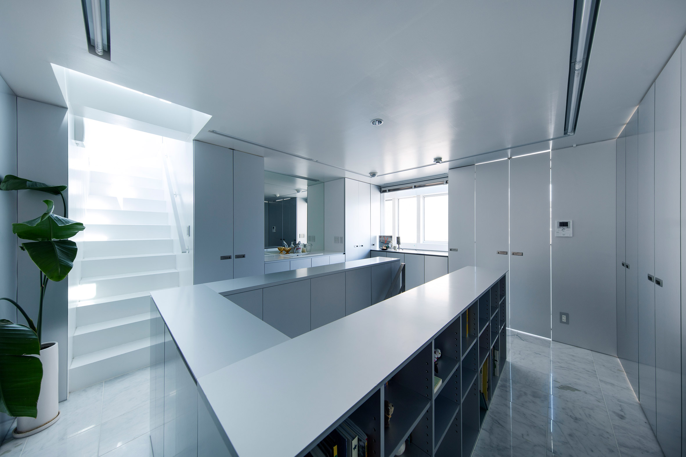 Galvanised steel panels cover irregularly stacked volumes of Japanese townhouse-12