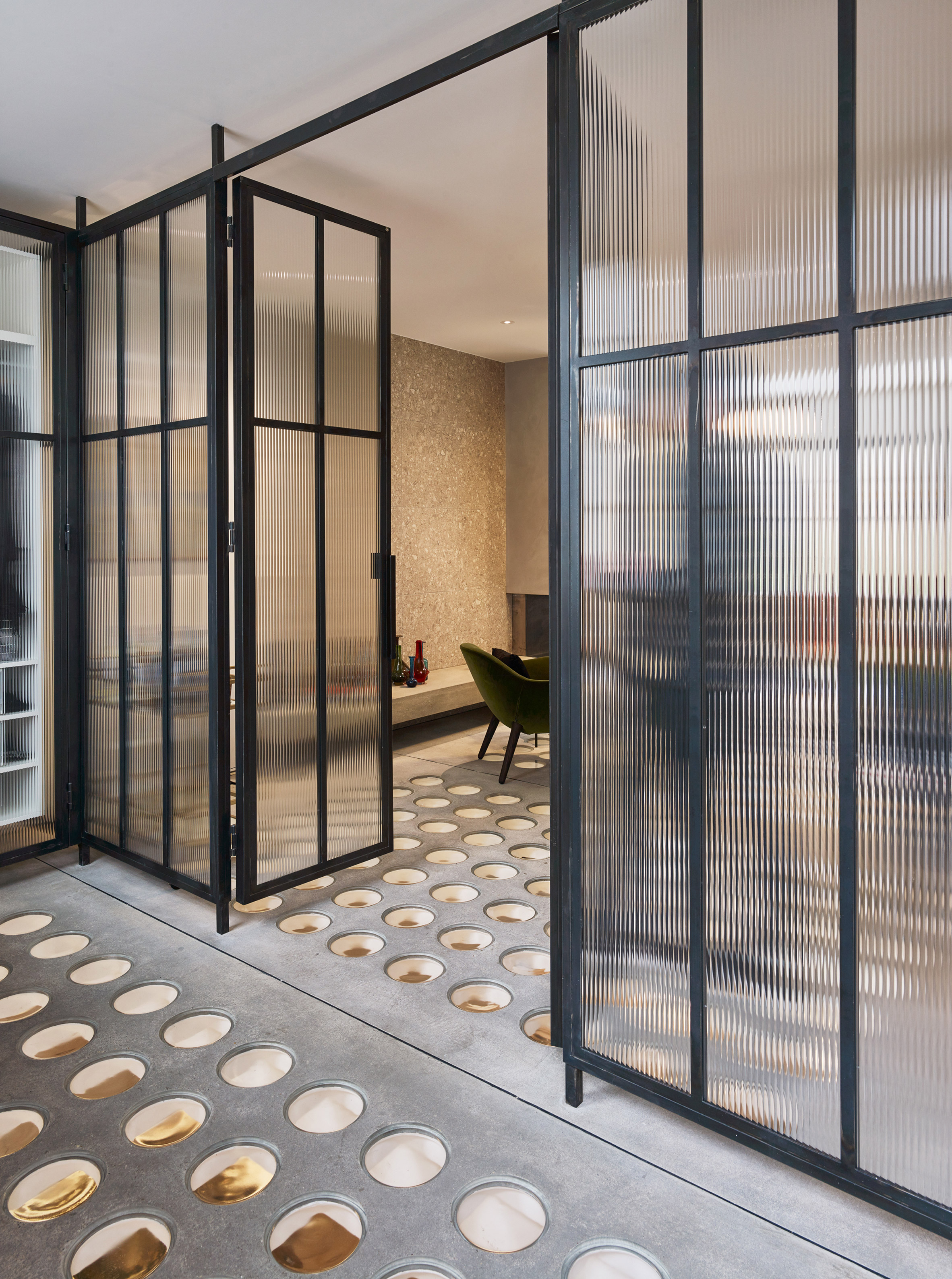 Perforated steel and pavement lights let the sun pierce Andy Martin Architecture's London townhouse-14