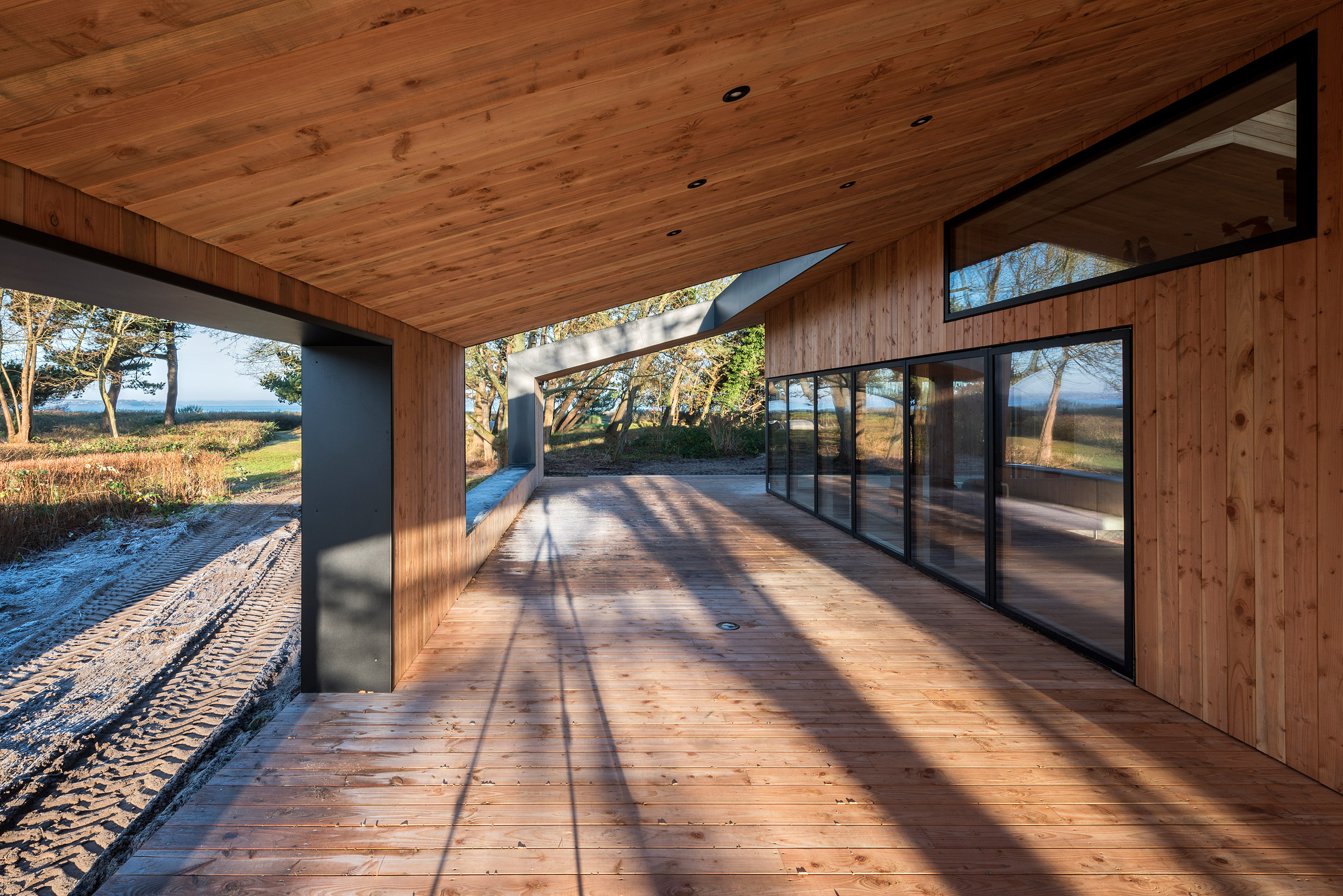 Oversized roof shelters terraces at CEBRA's Danish summer house-11