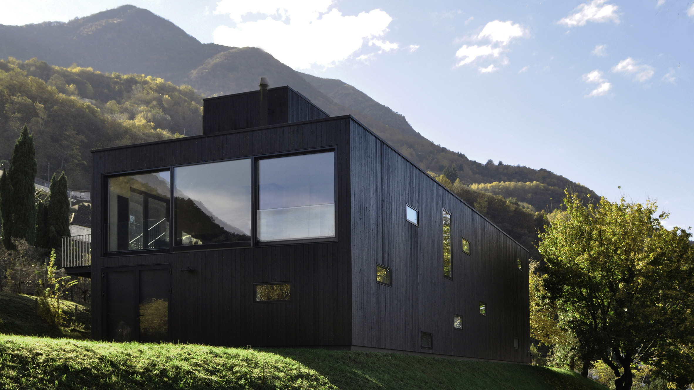 This prefabricated wooden holiday home is clad in charred timber boards-0
