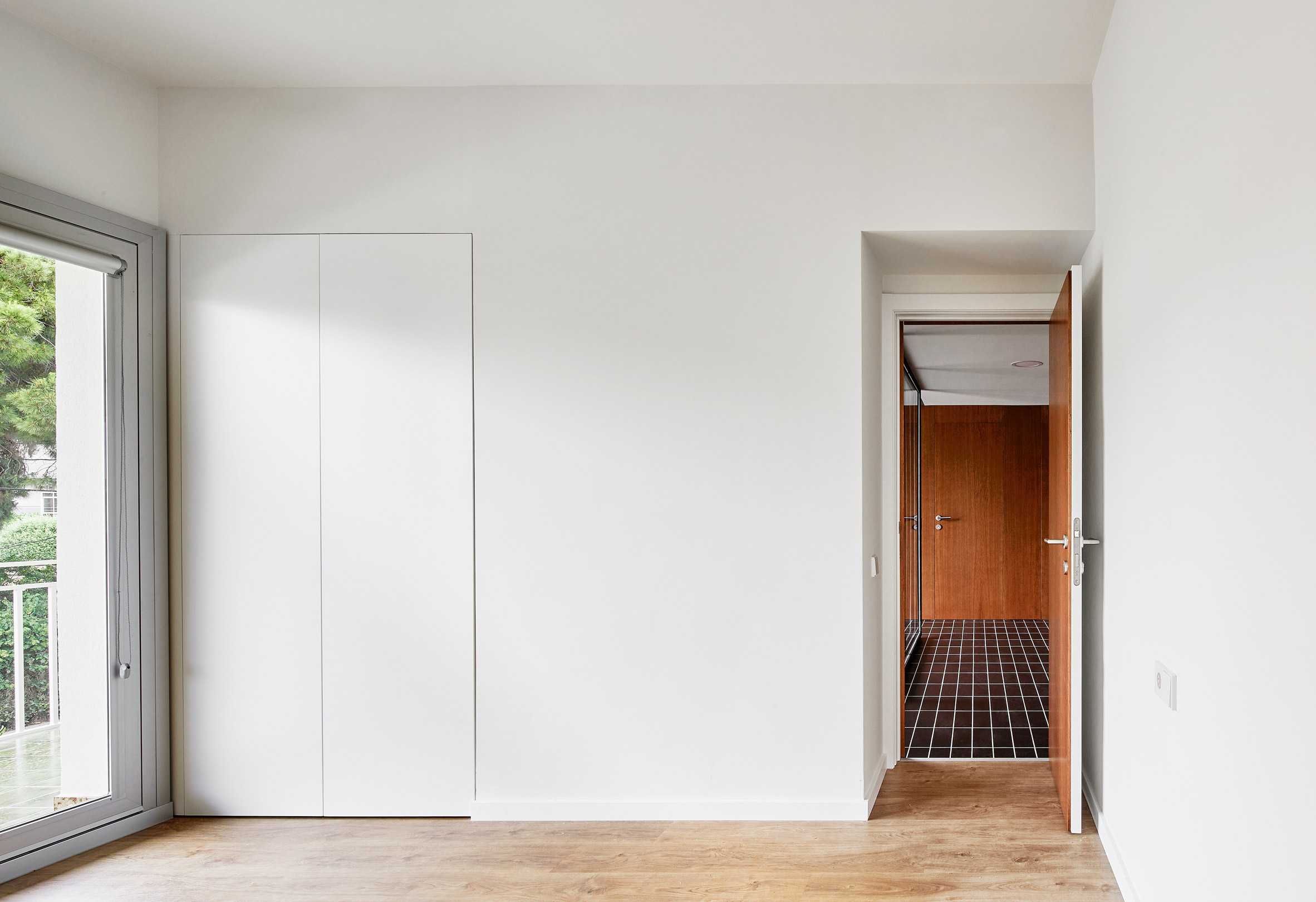 Revamped Barcelona house features herringbone floors and a covert dining area-17