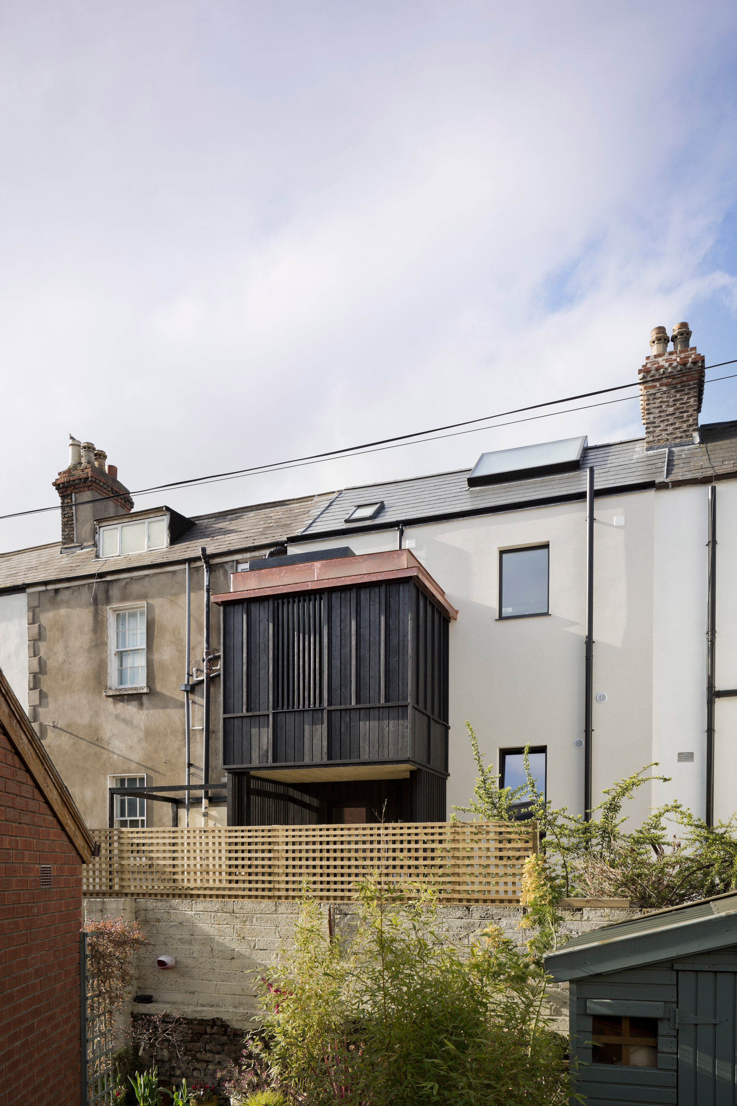 Scullion Architects adds charred-larch tower to terraced home in Dublin-2