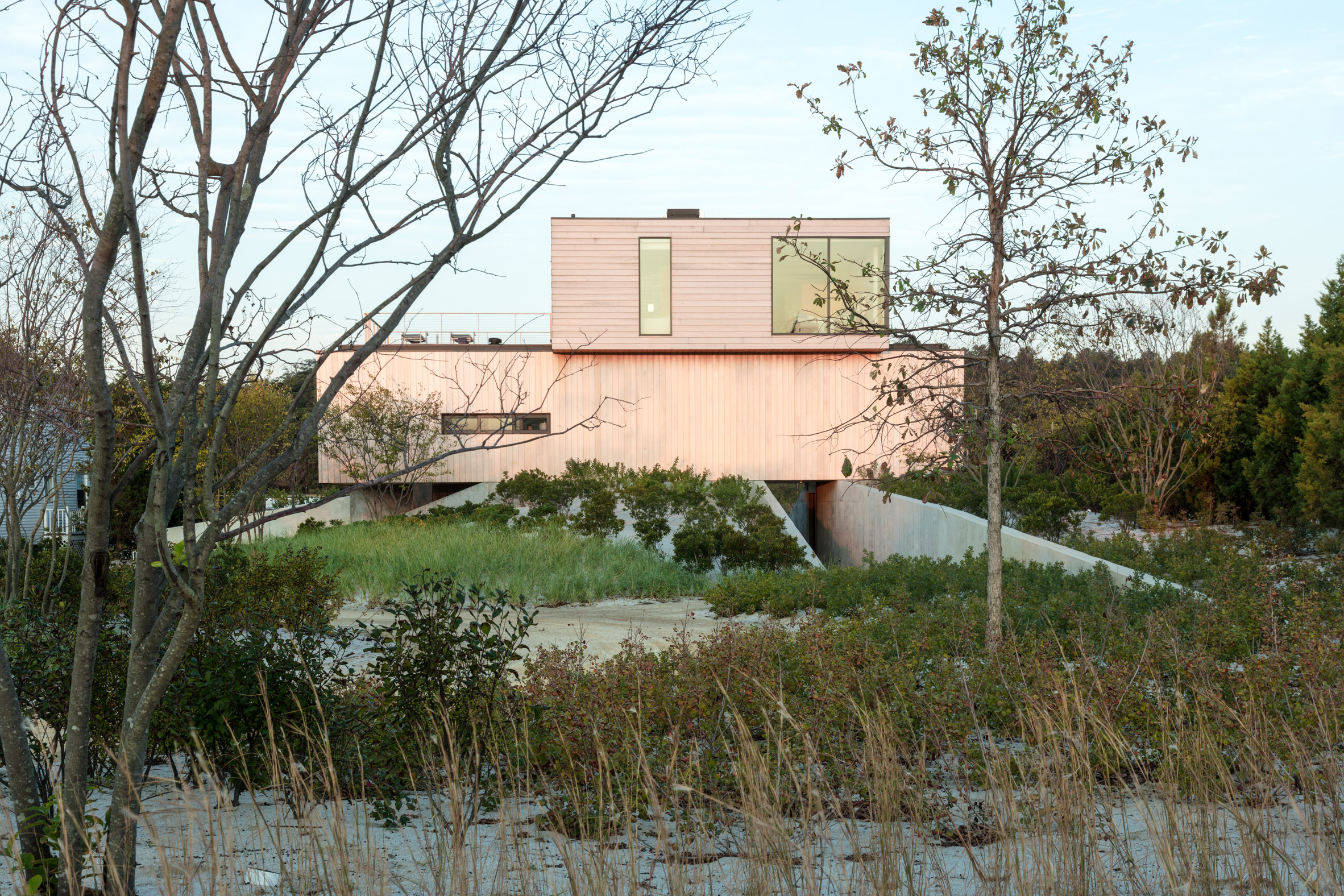 Pale cedar beach house by Raad Studio perches atop a sand dune-17